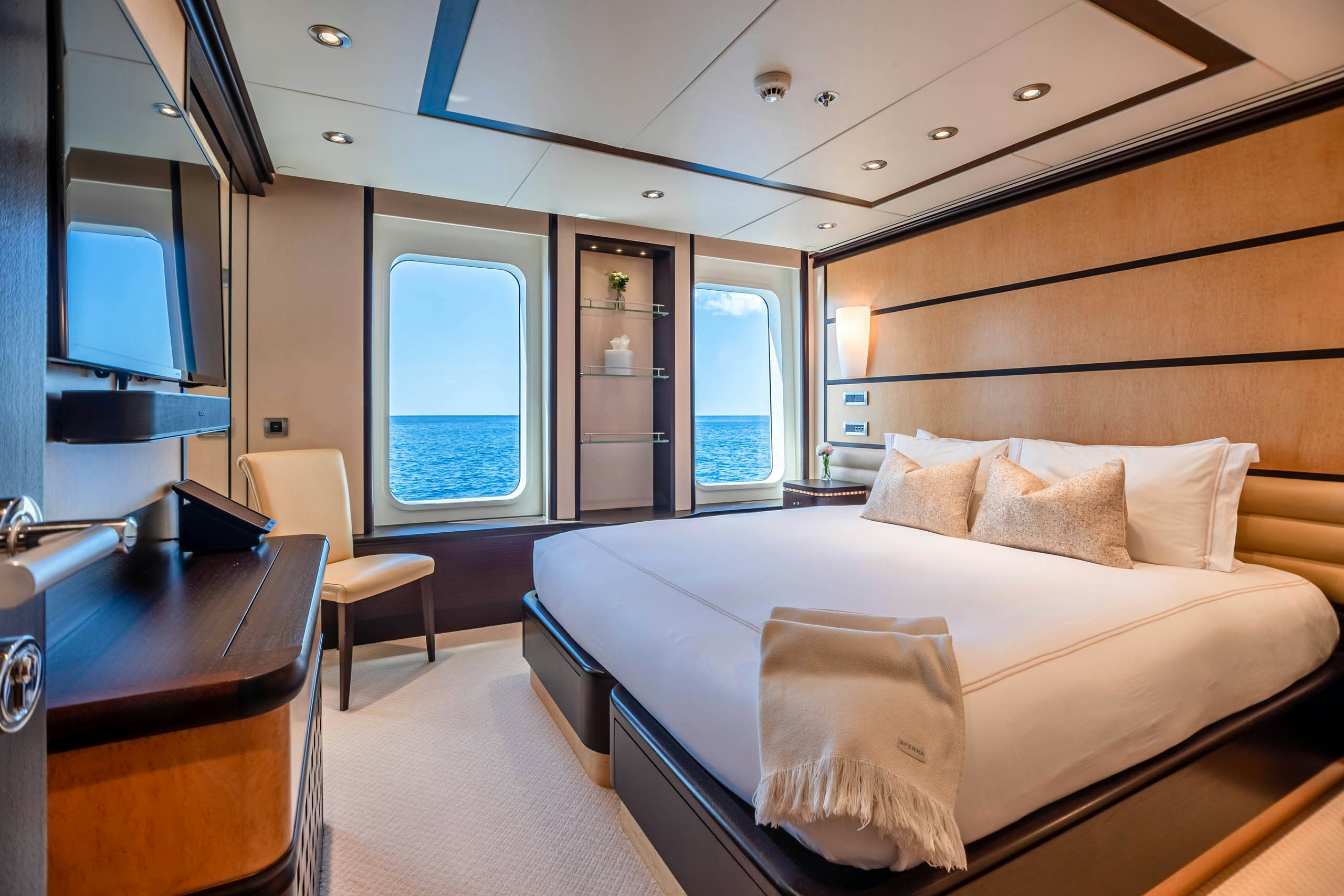 a room with a bed and a desk aboard HARLE Yacht for Charter