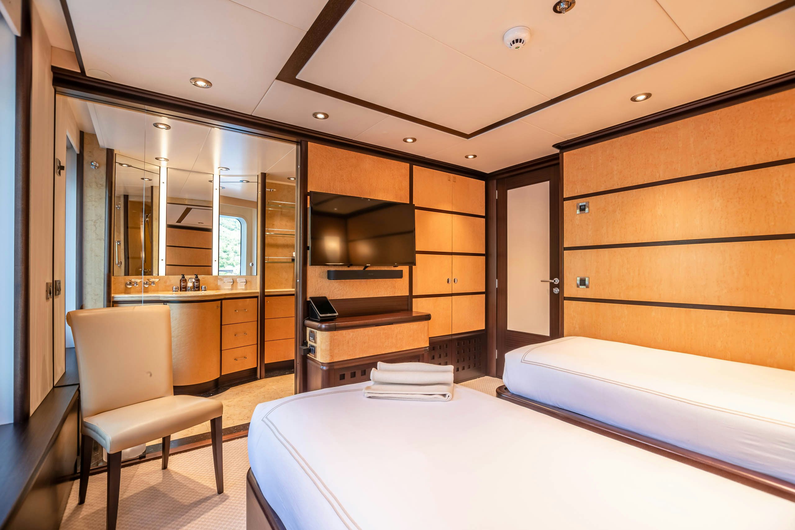 a room with a bed and a chair aboard HARLE Yacht for Charter