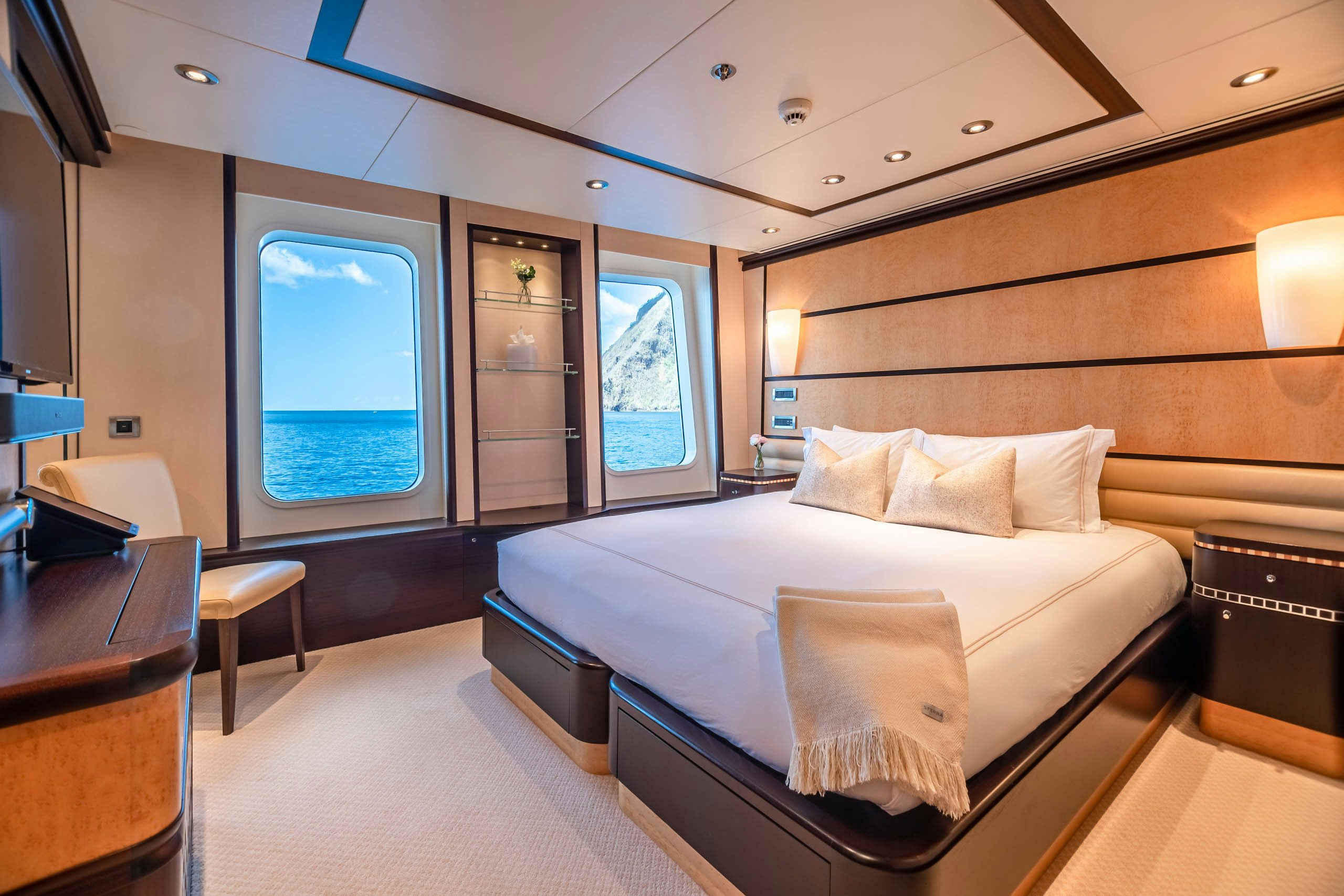 a room with a bed and a desk aboard HARLE Yacht for Charter