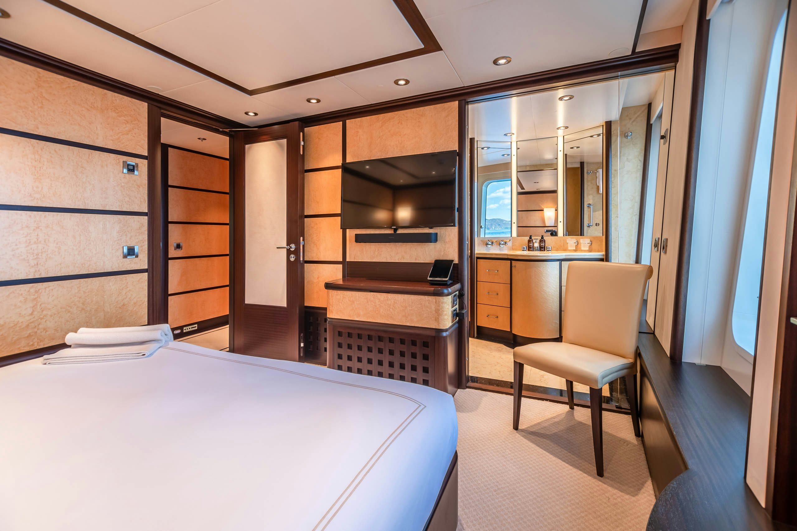 a room with a bed and a desk aboard HARLE Yacht for Charter