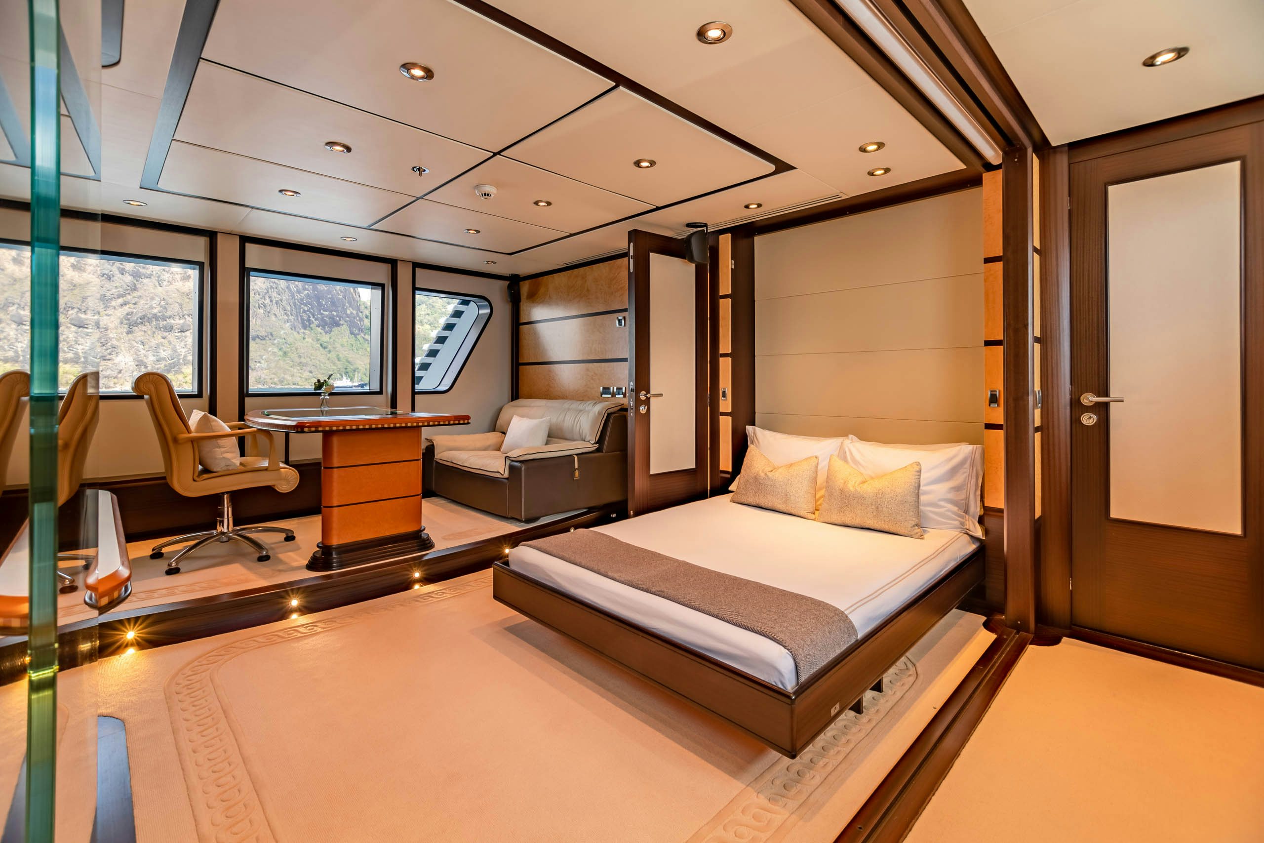 a room with a bed and a couch aboard HARLE Yacht for Charter