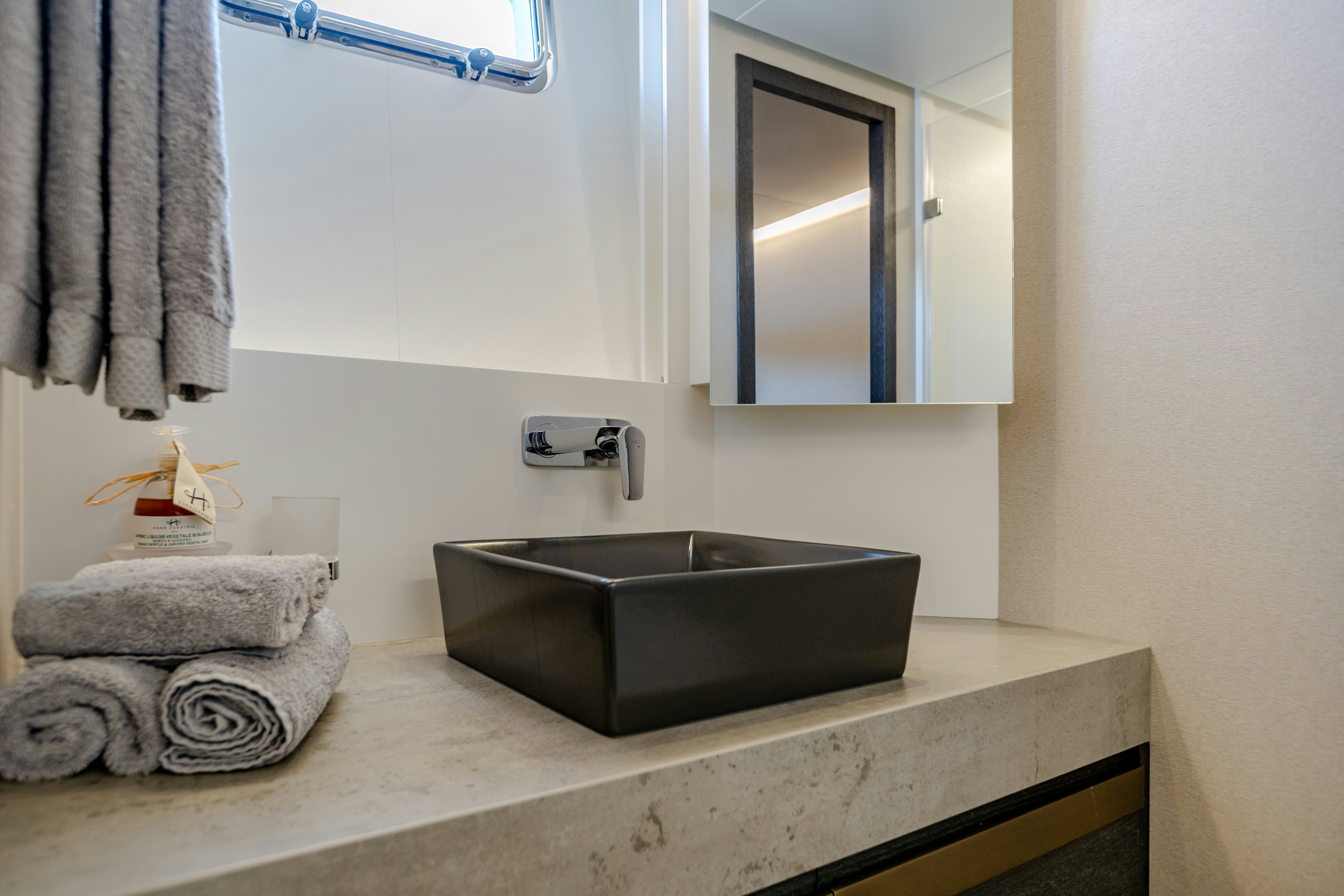 a bathroom with a sink and a mirror aboard MAORIA Yacht for Sale