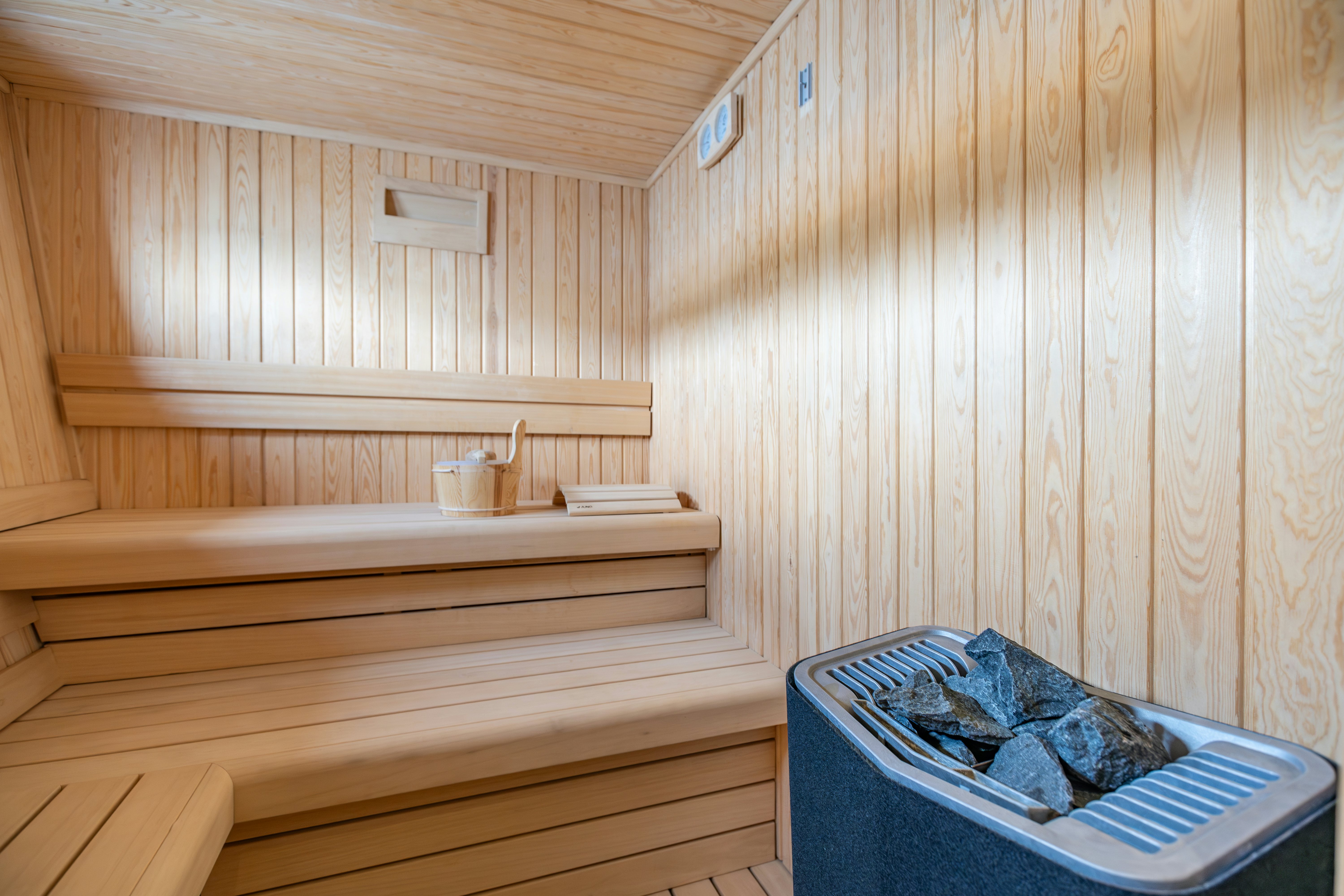 a bed with a blue blanket aboard MAORIA Yacht for Sale