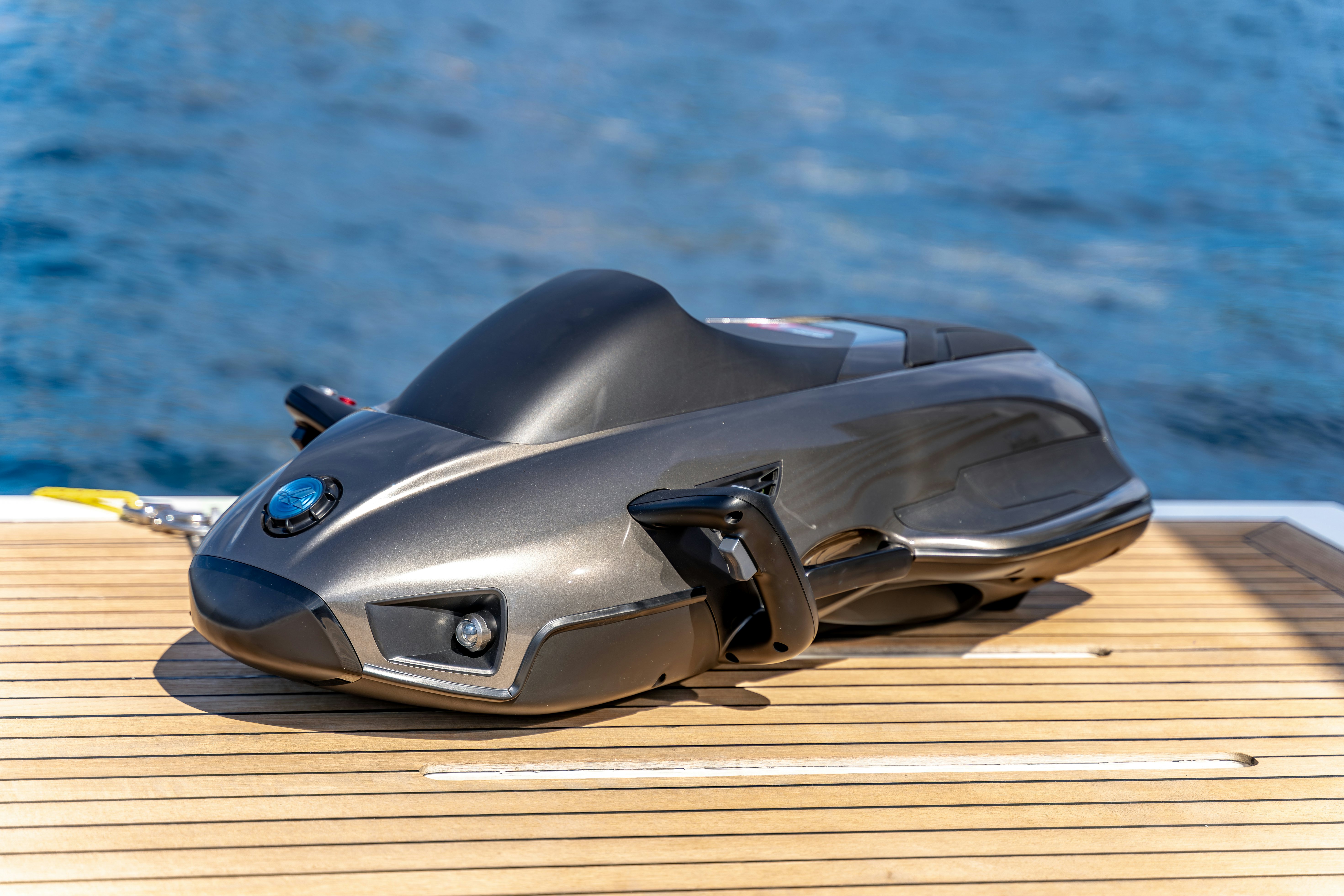 a black sports car on a deck aboard MAORIA Yacht for Sale
