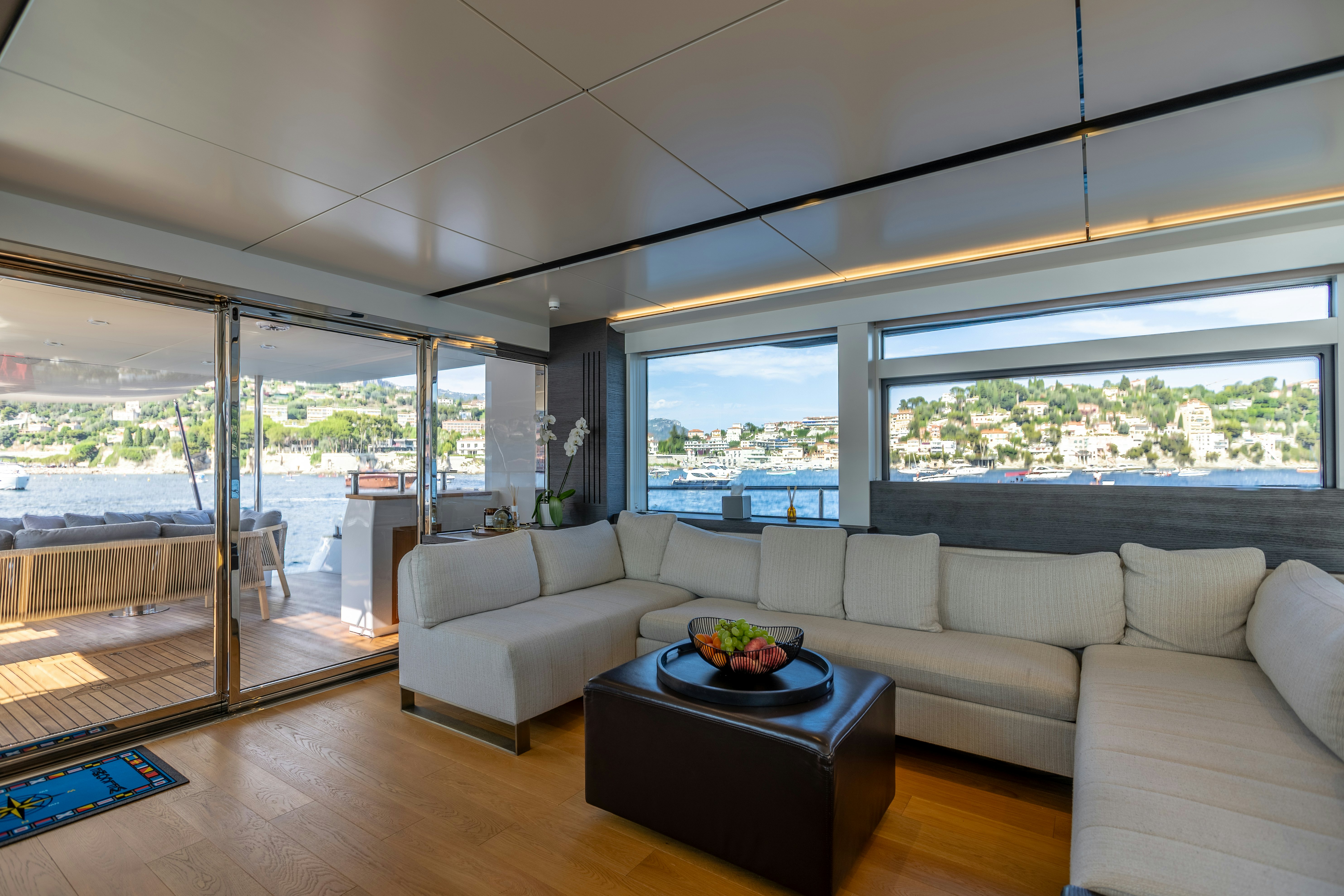 a living room with a large window aboard MAORIA Yacht for Sale