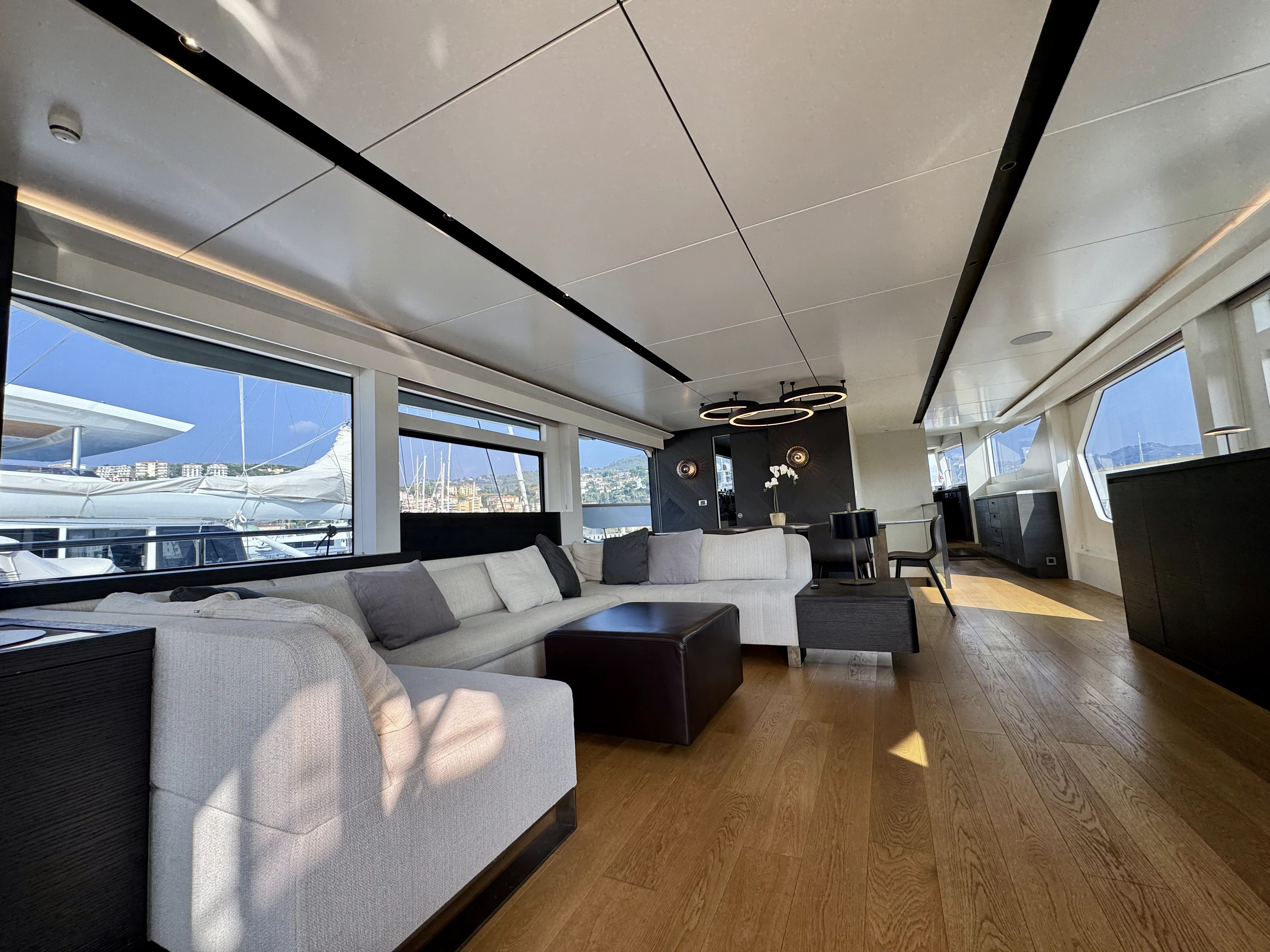 a room with couches and a large window aboard MAORIA Yacht for Charter