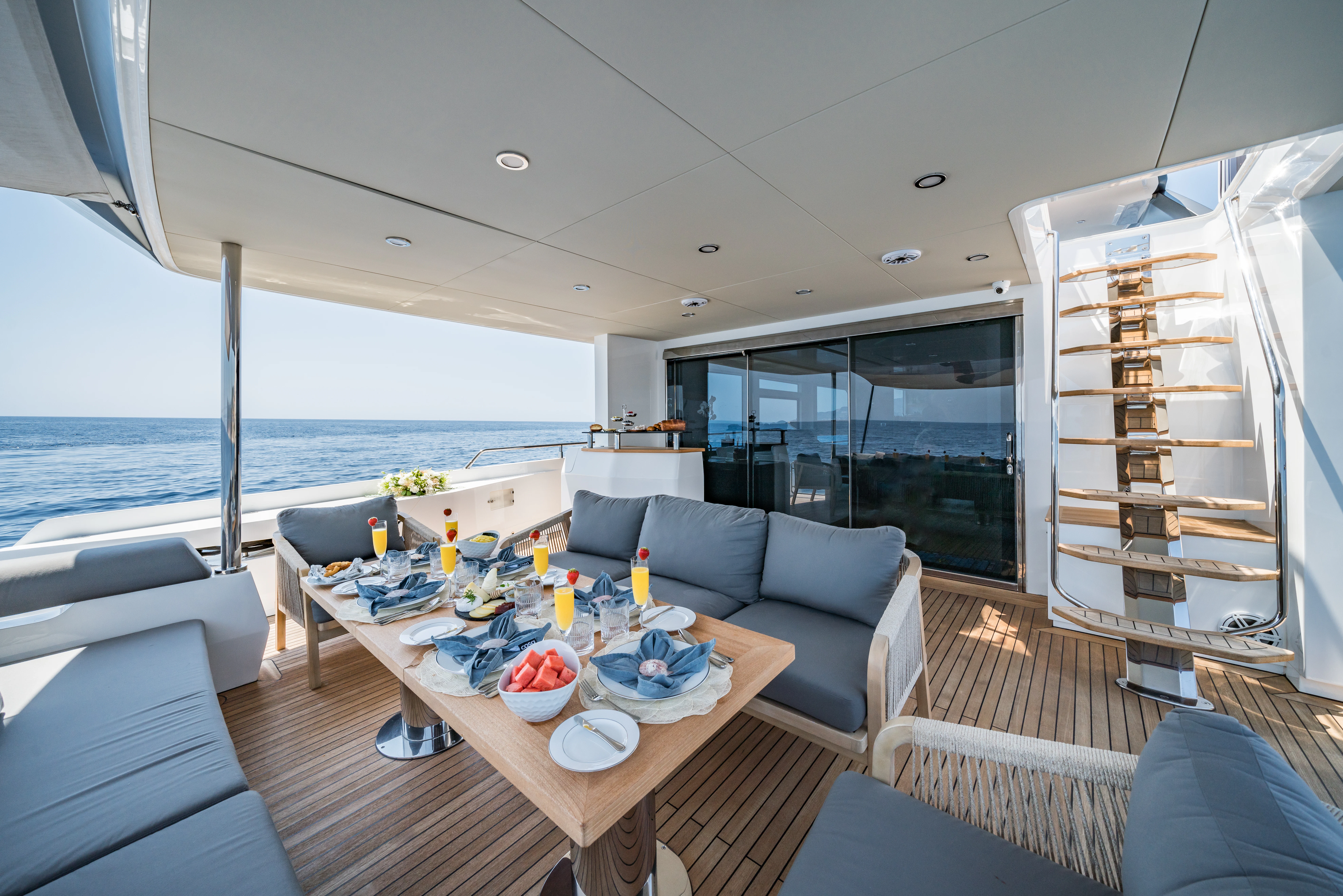 a living room with a large window aboard MAORIA Yacht for Charter
