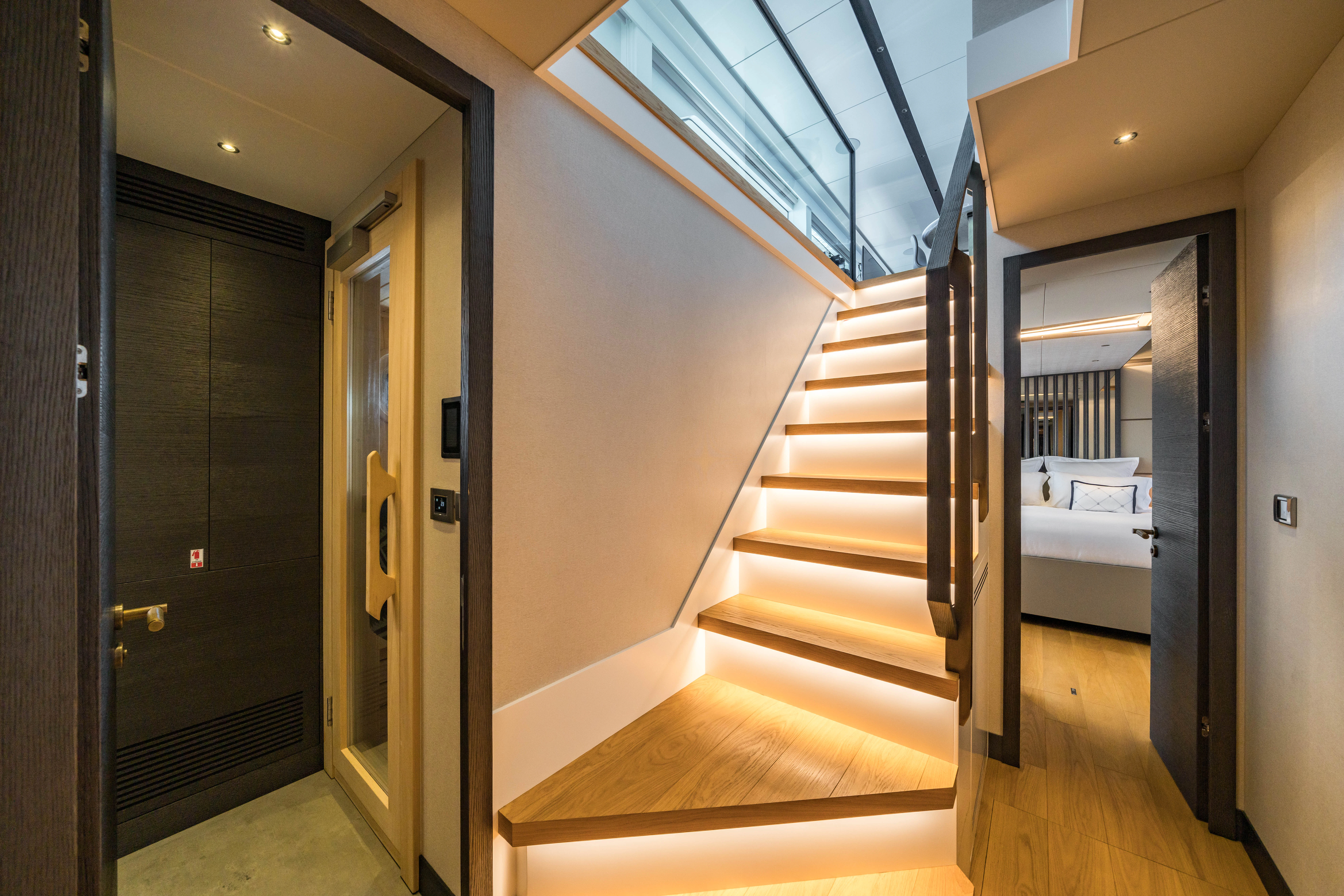 a hallway with a bed and a door aboard MAORIA Yacht for Charter