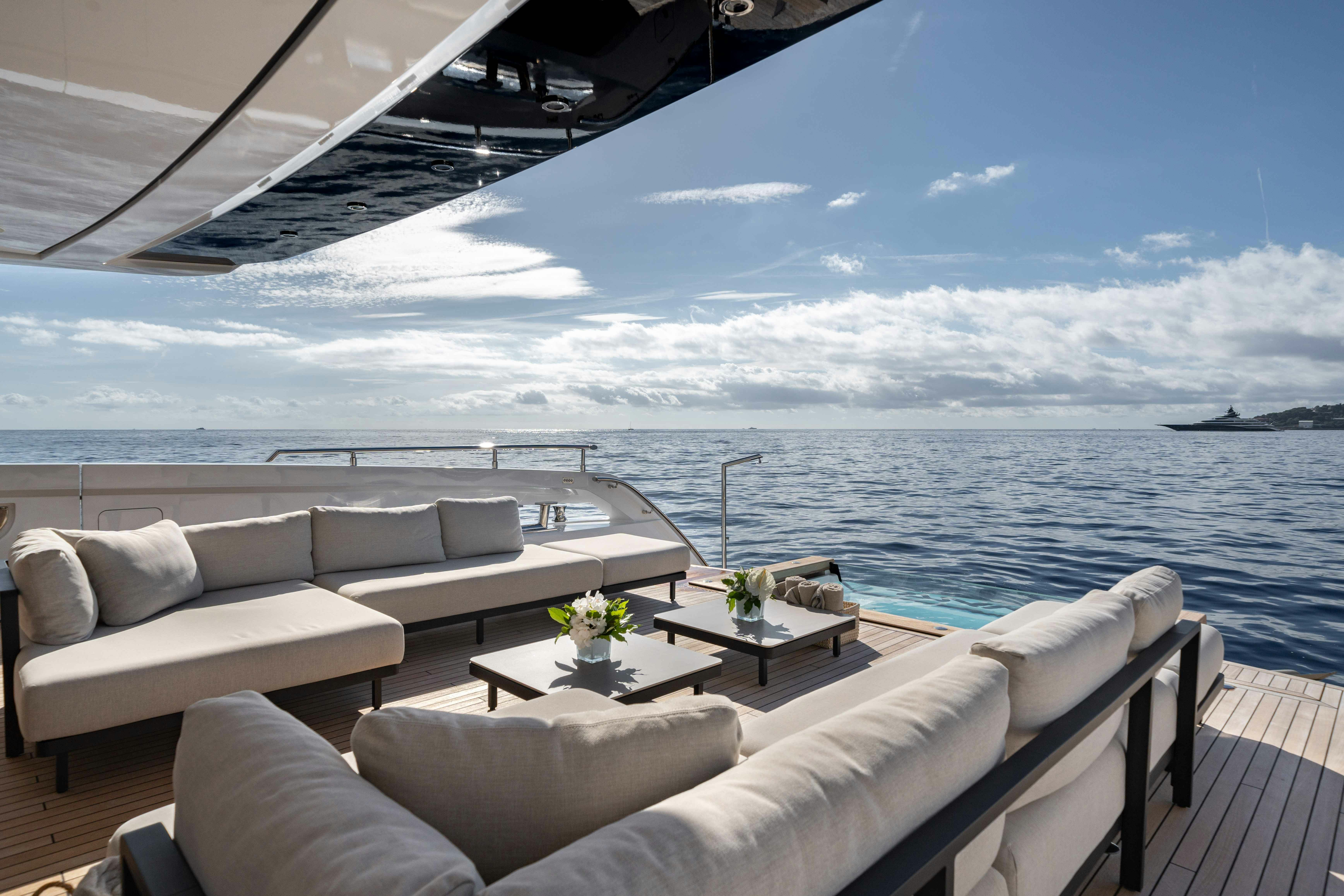 a large white sofa and a table on a boat aboard OCEAN KING DUCALE 120 Yacht for Sale