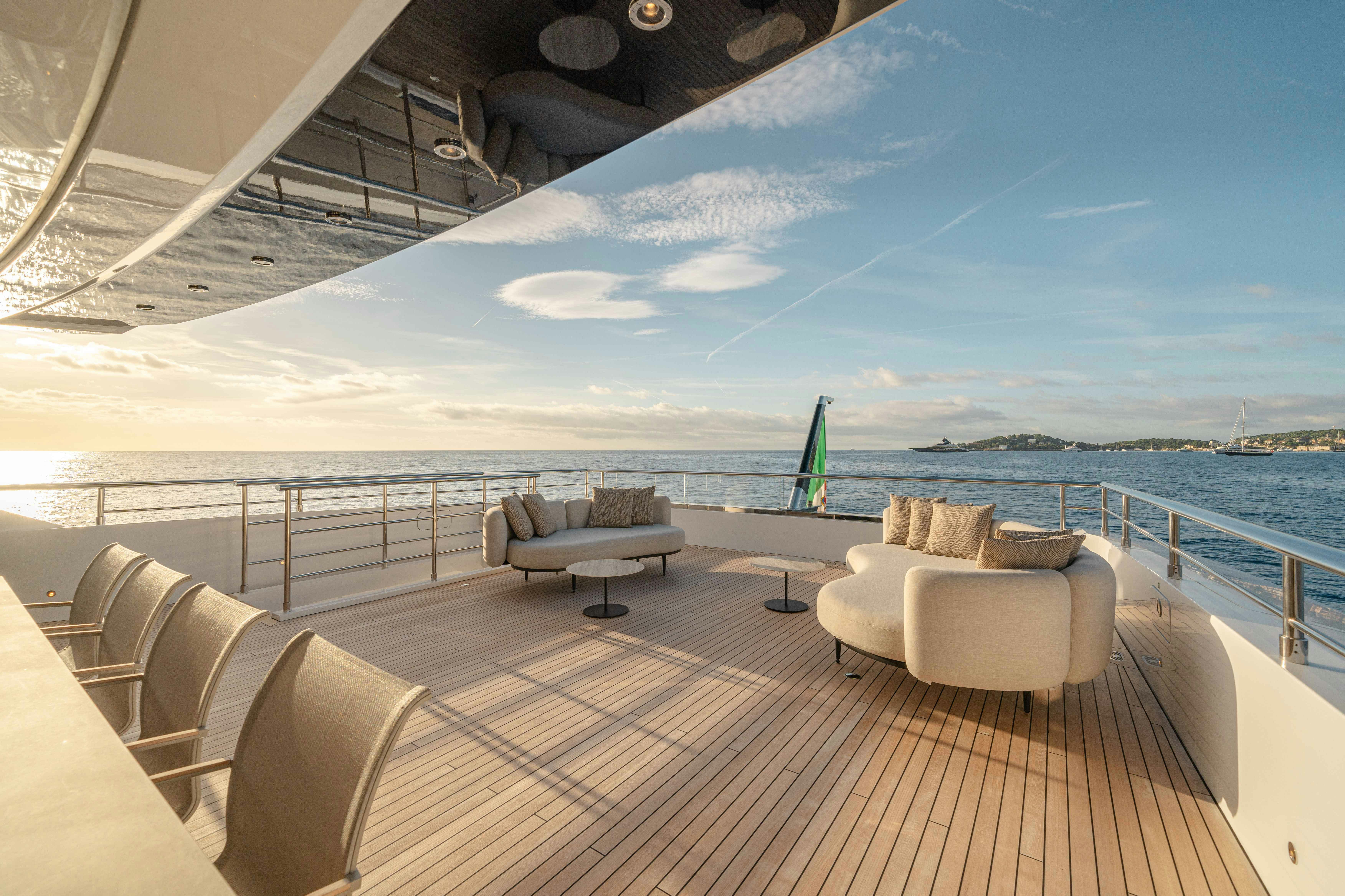 a deck with chairs and a body of water aboard OCEAN KING DUCALE 120 Yacht for Sale
