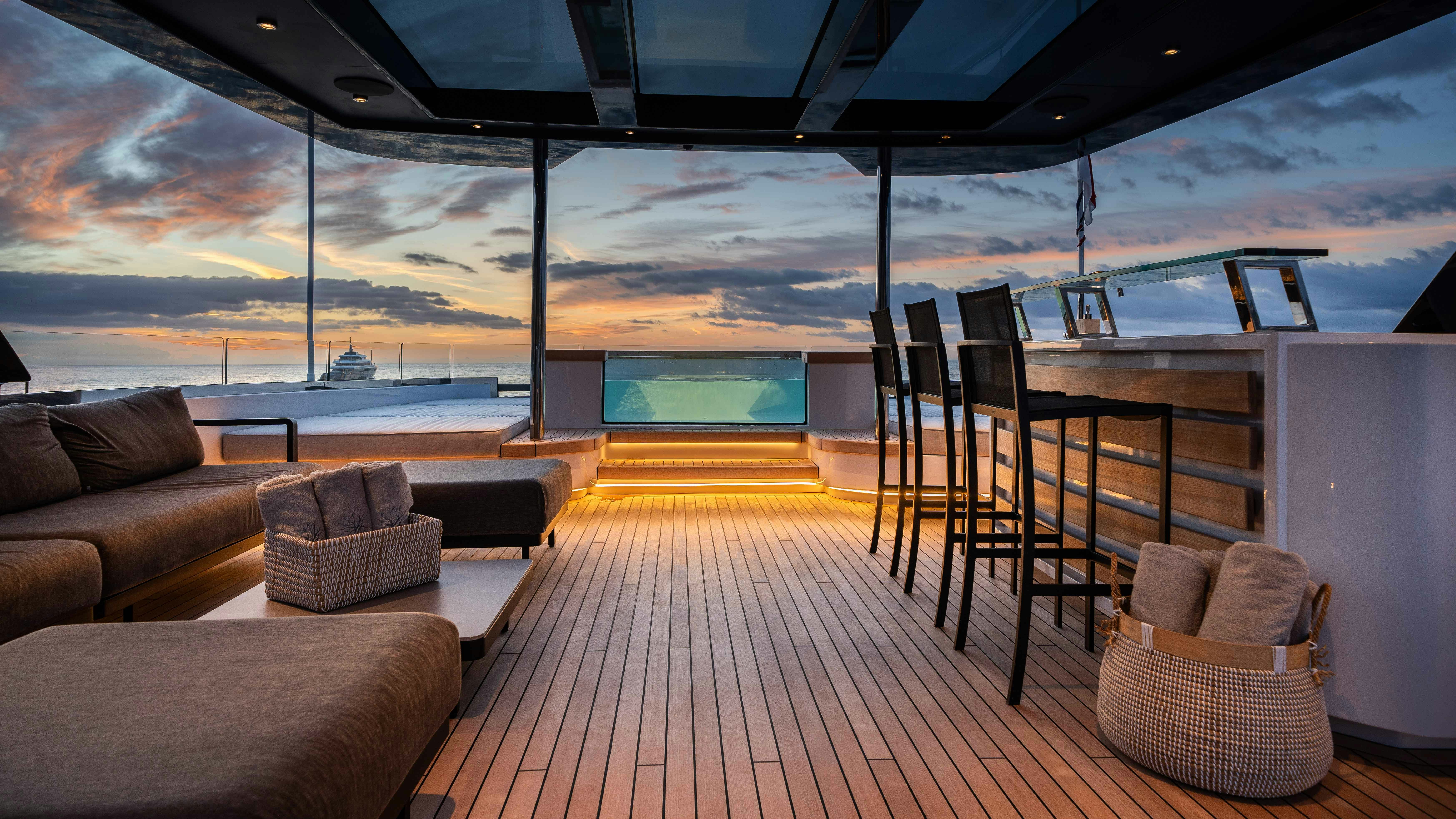 a room with a couch and a table and chairs aboard OCEAN KING DUCALE 120 Yacht for Sale