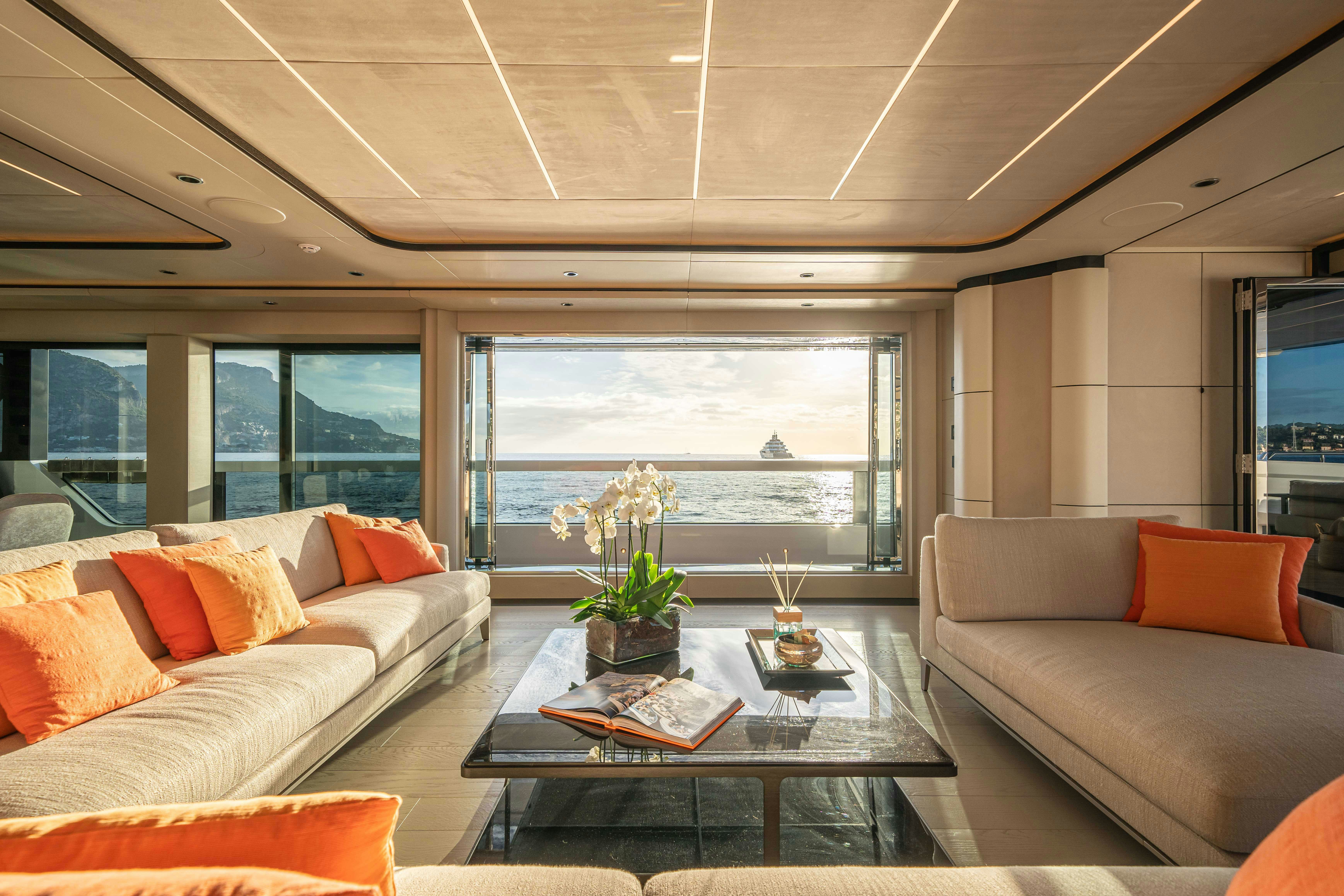 a living room with a table and couches aboard OCEAN KING DUCALE 120 Yacht for Sale