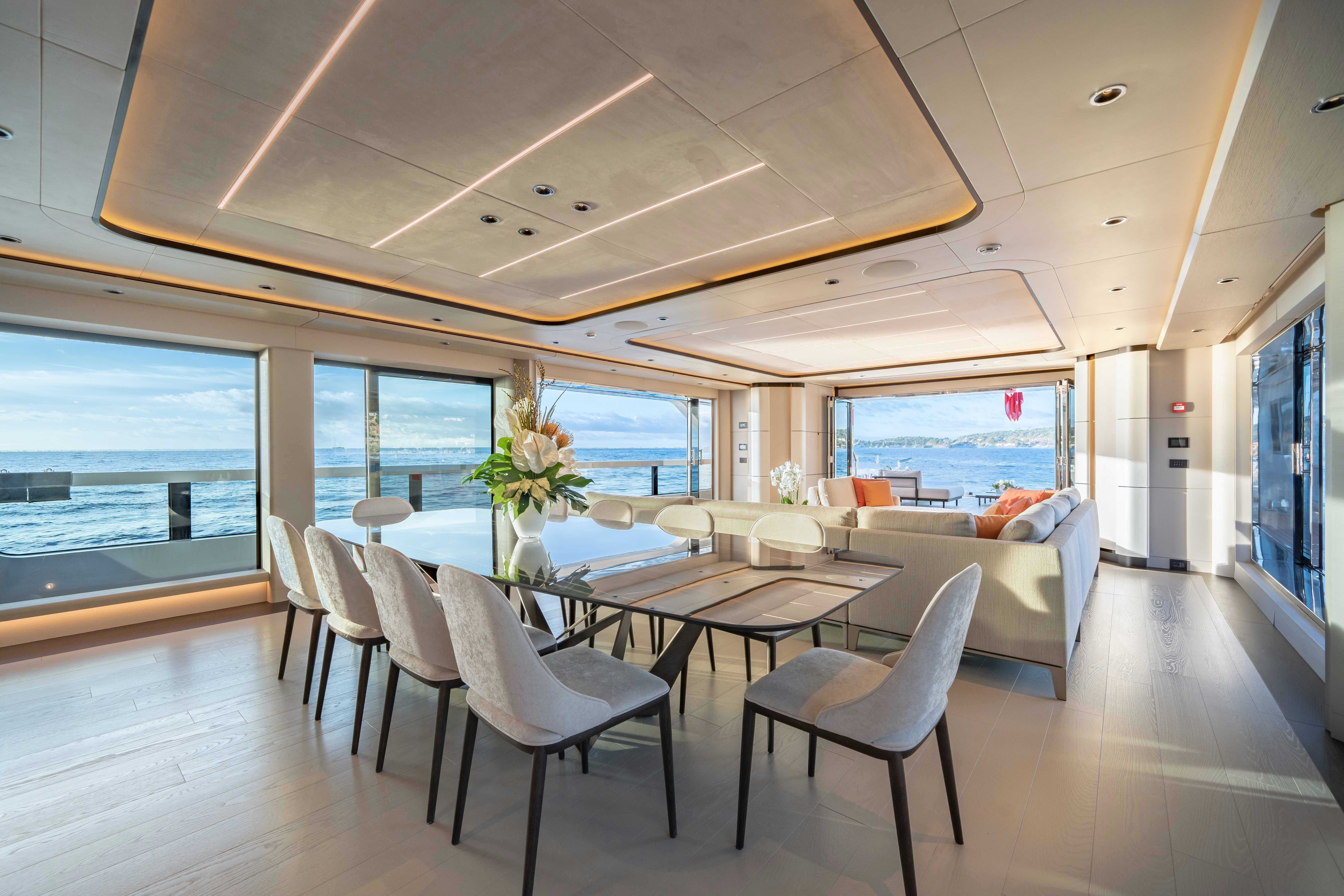 a room with a table and chairs aboard OCEAN KING DUCALE 120 Yacht for Sale