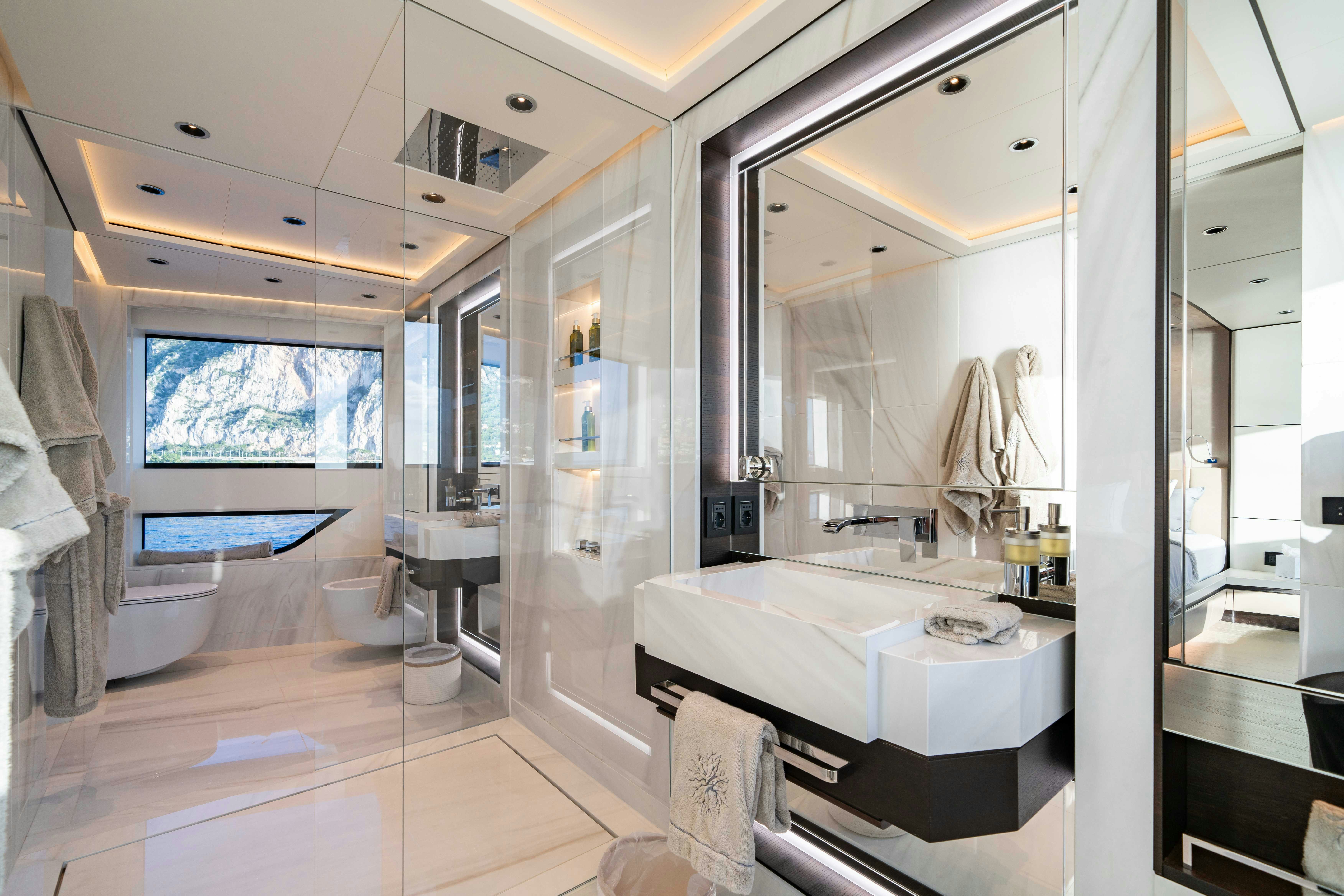 a bathroom with a large mirror aboard OCEAN KING DUCALE 120 Yacht for Sale