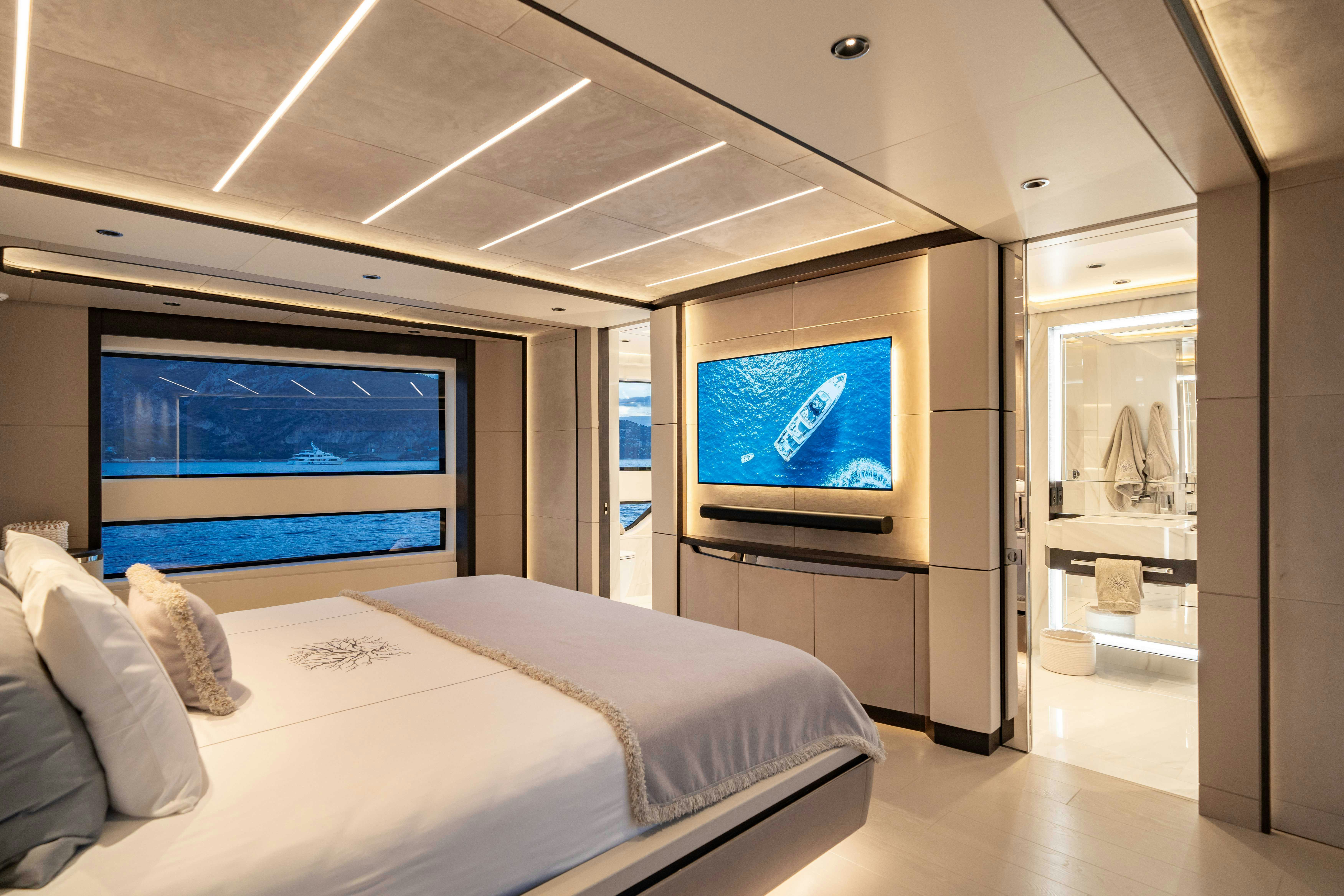 a room with a bed and a tv aboard OCEAN KING DUCALE 120 Yacht for Sale