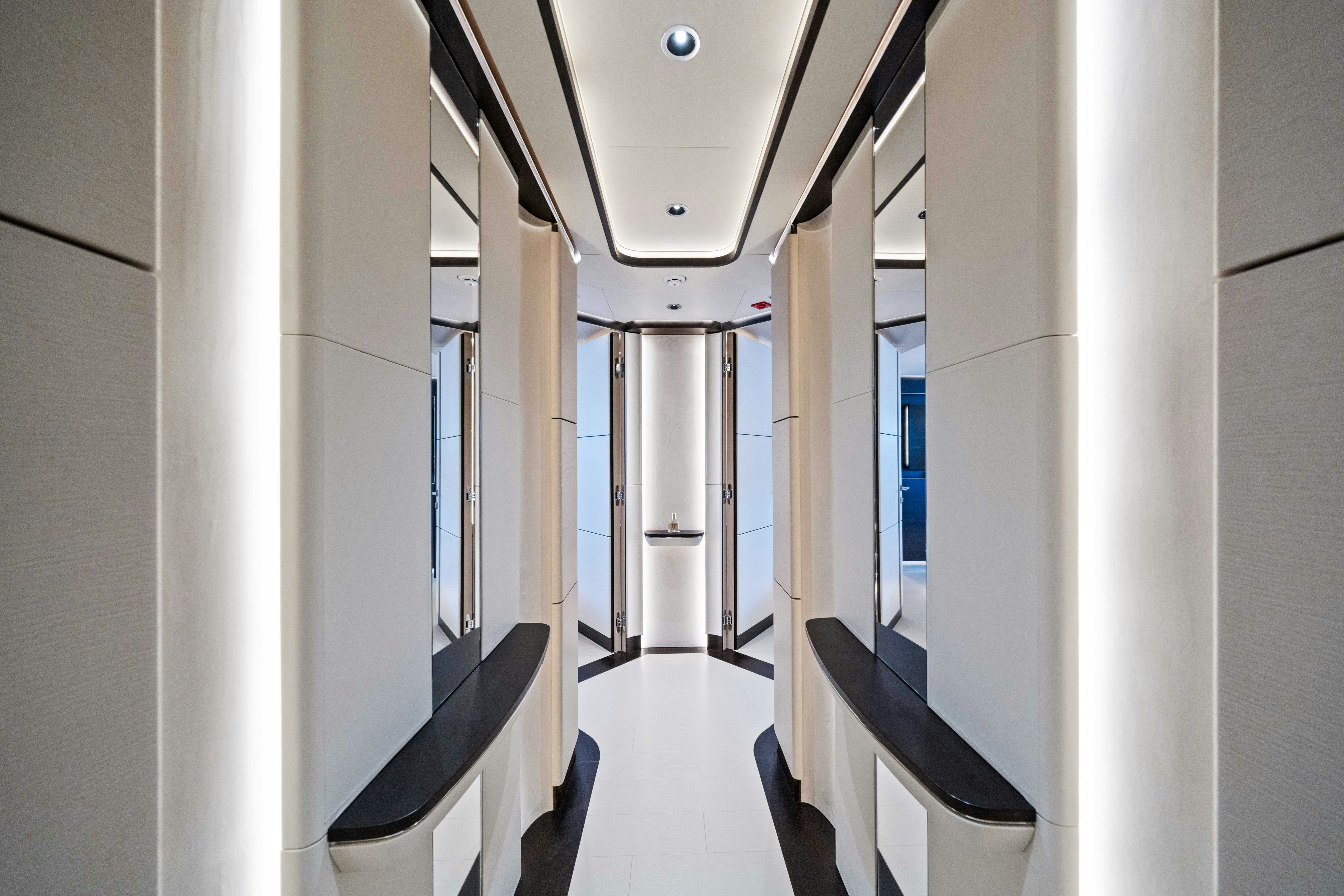 a hallway with white walls aboard OCEAN KING DUCALE 120 Yacht for Sale