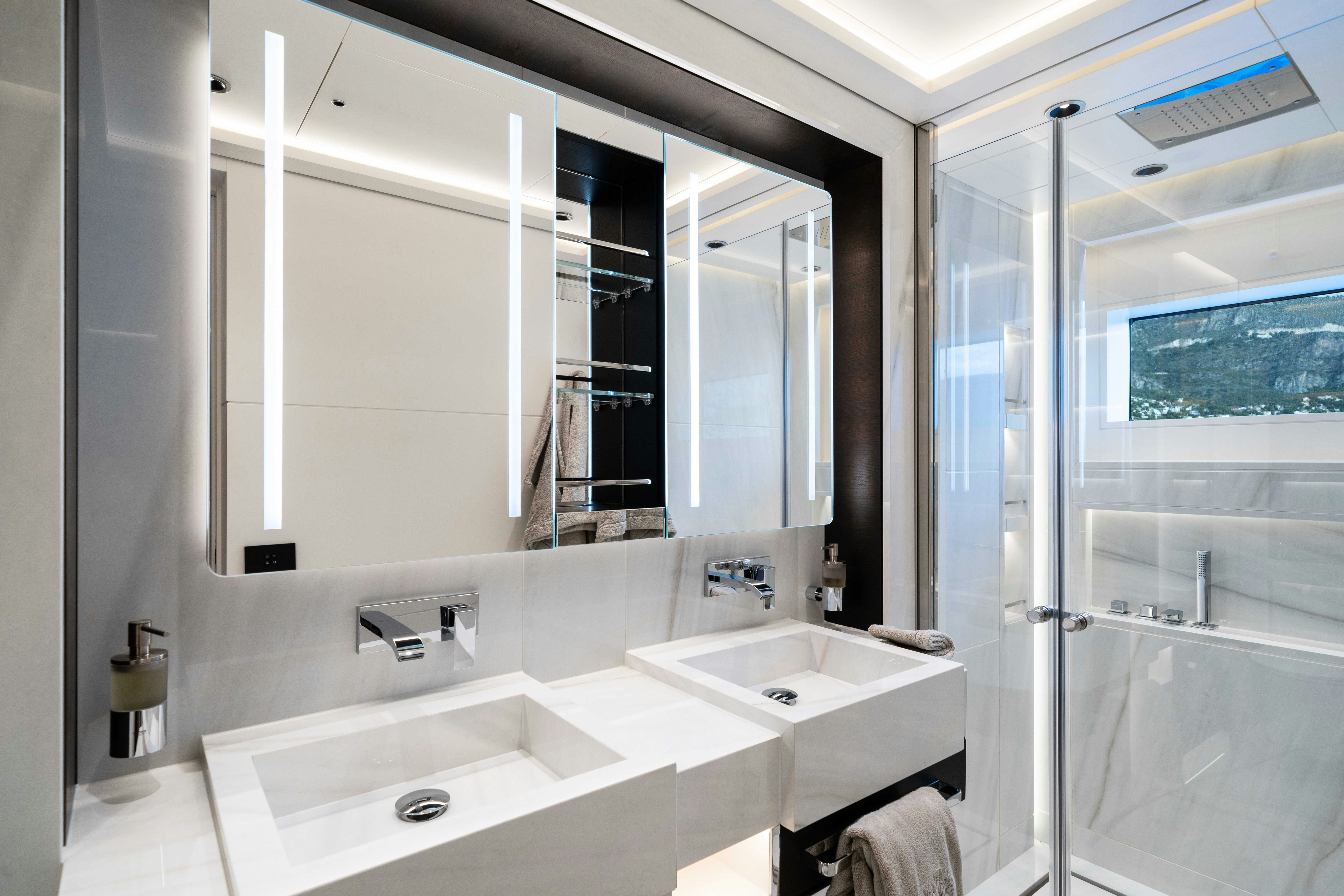 a bathroom with a large mirror aboard OCEAN KING DUCALE 120 Yacht for Sale