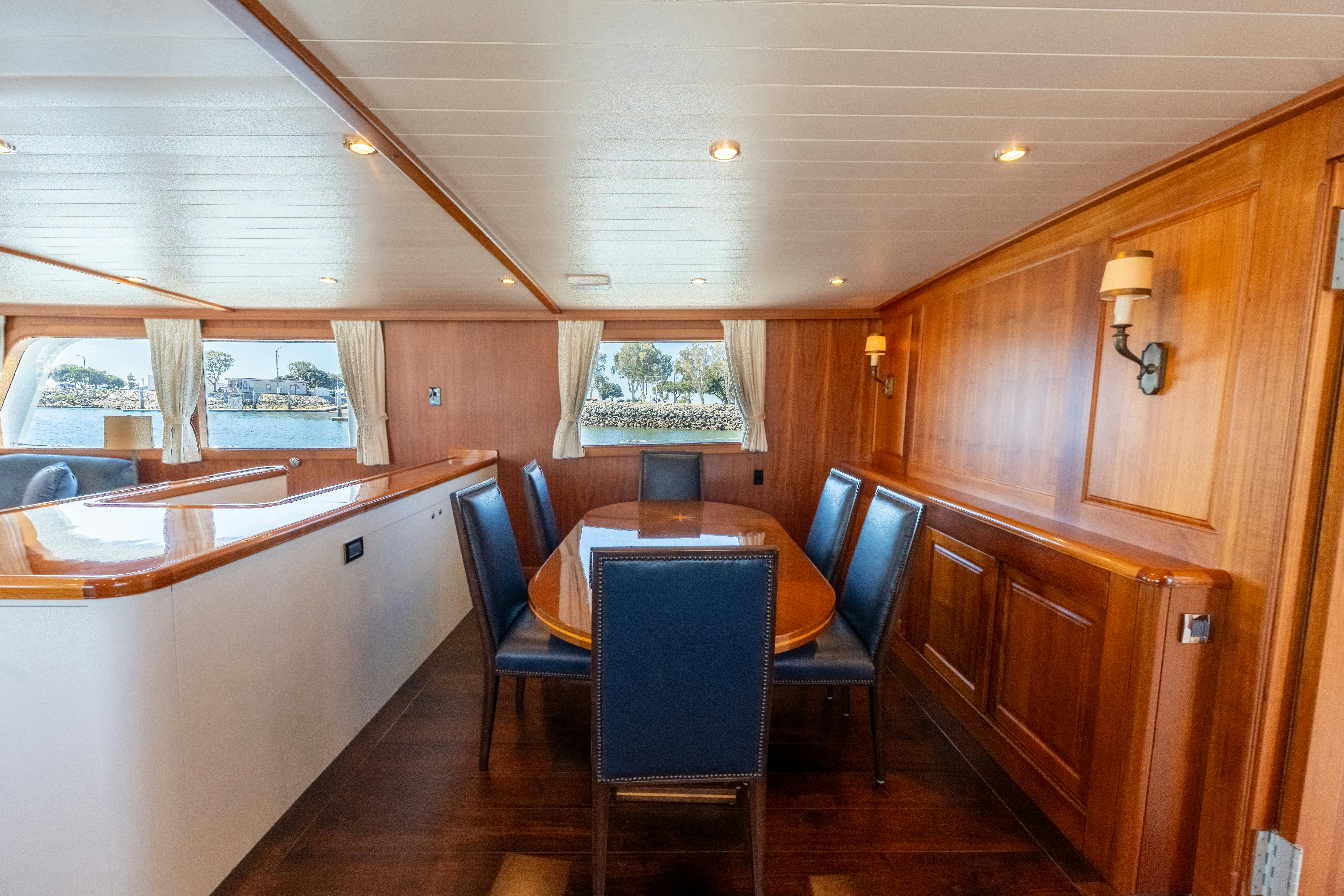 a wood paneled room with a table and chairs aboard NORDIC STAR Yacht for Sale