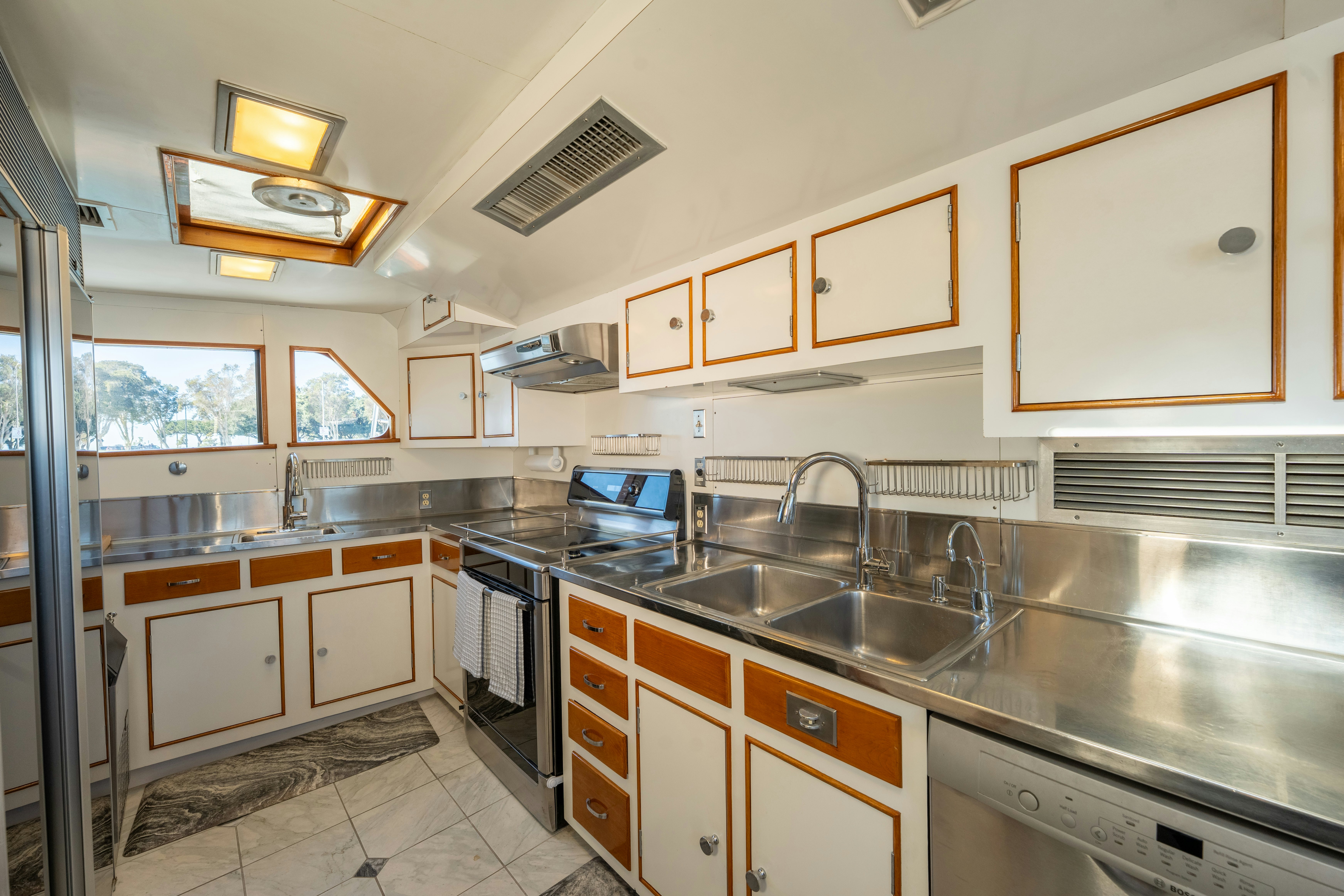 a kitchen with a sink and a laptop aboard NORDIC STAR Yacht for Sale