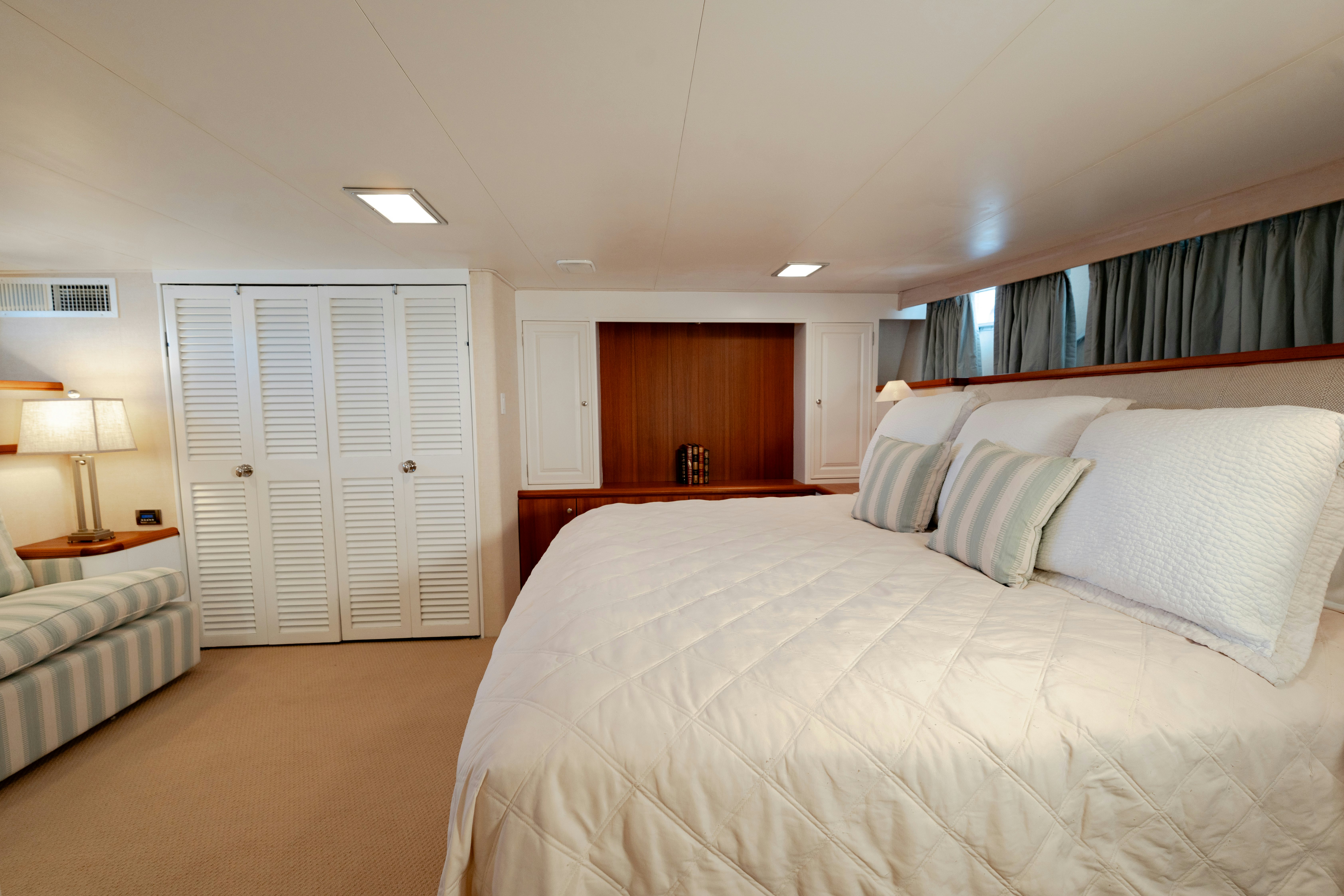 a bedroom with a bed and a desk aboard NORDIC STAR Yacht for Sale