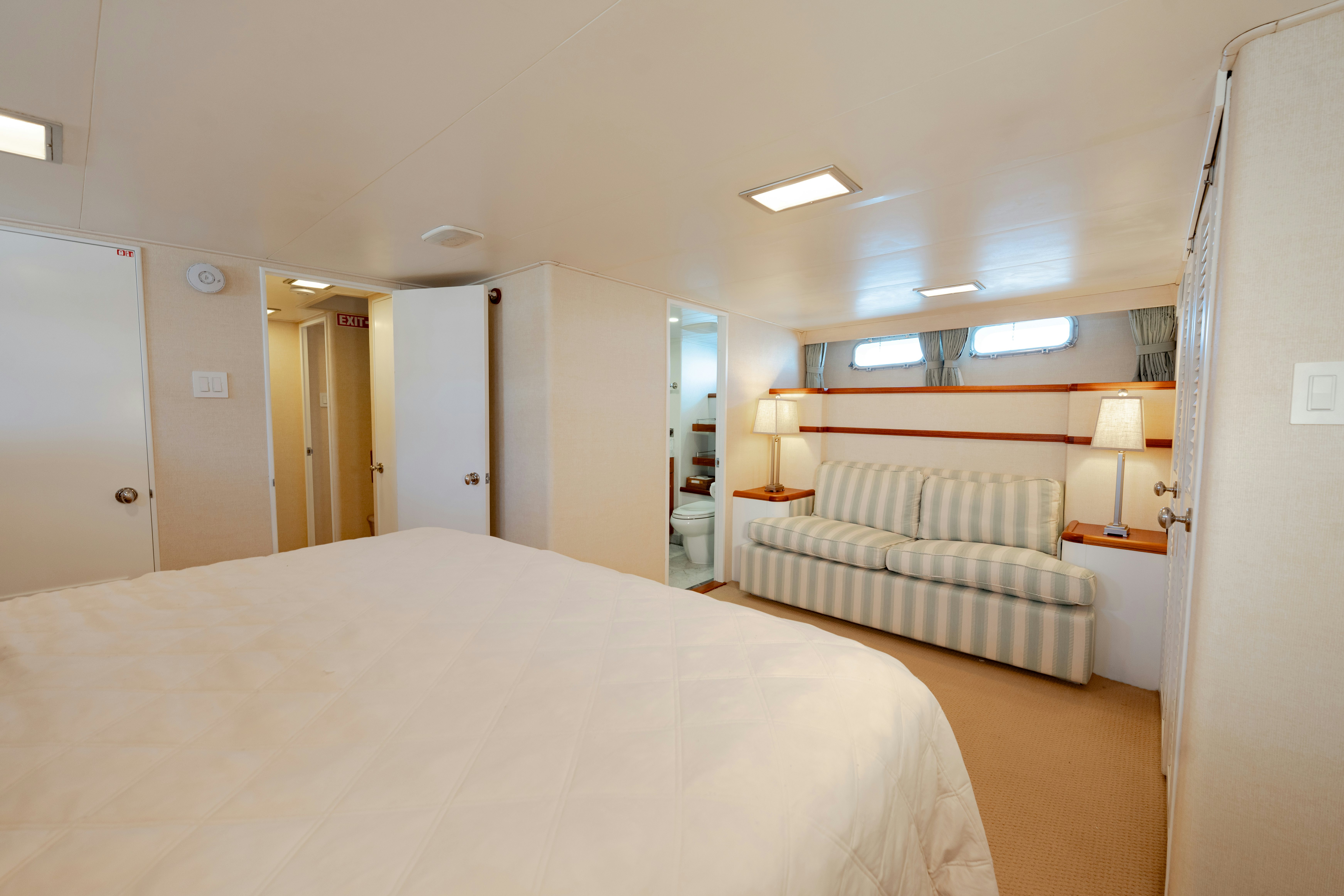 a bedroom with a bed and a desk aboard NORDIC STAR Yacht for Sale