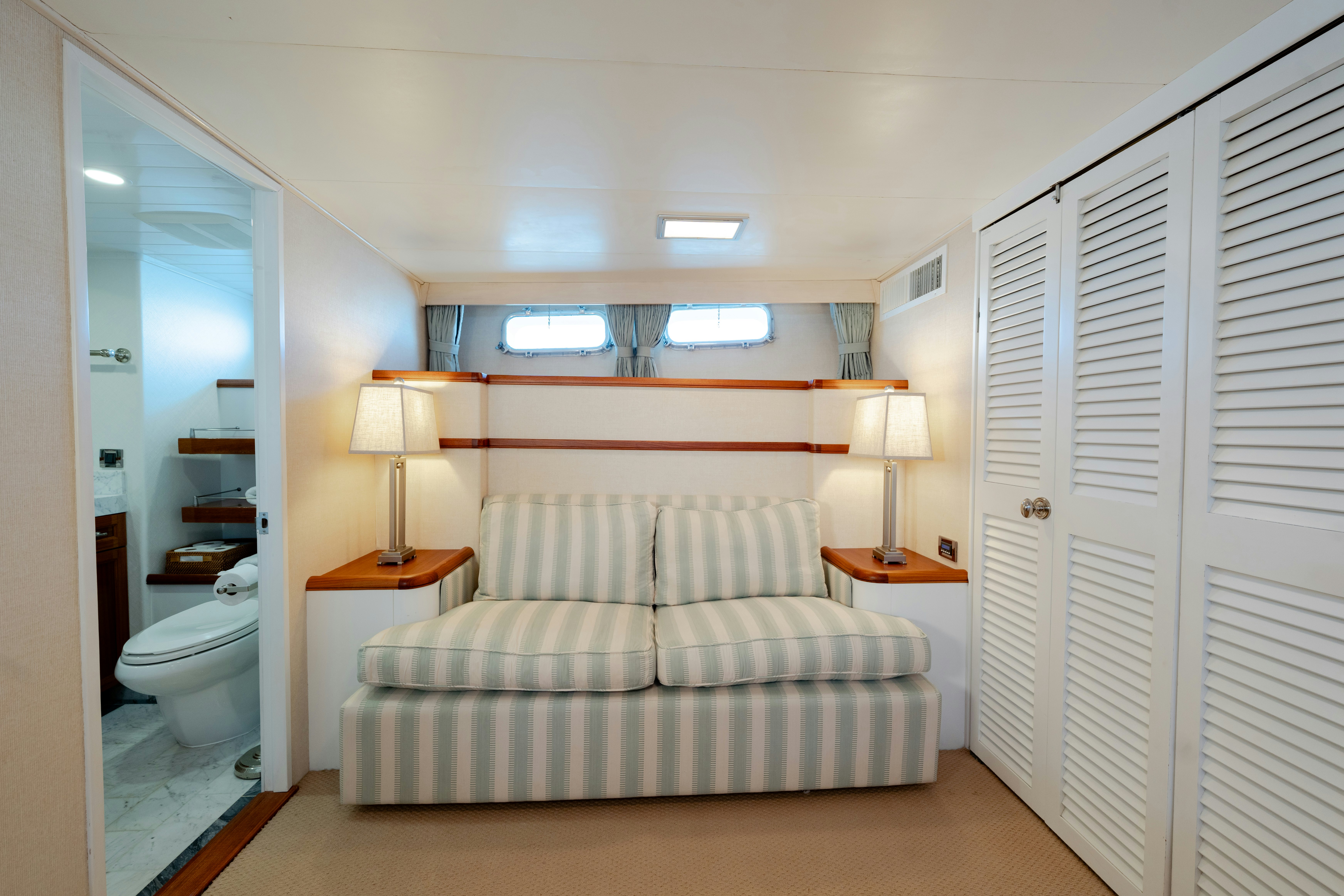 a bedroom with a bed and a desk aboard NORDIC STAR Yacht for Sale