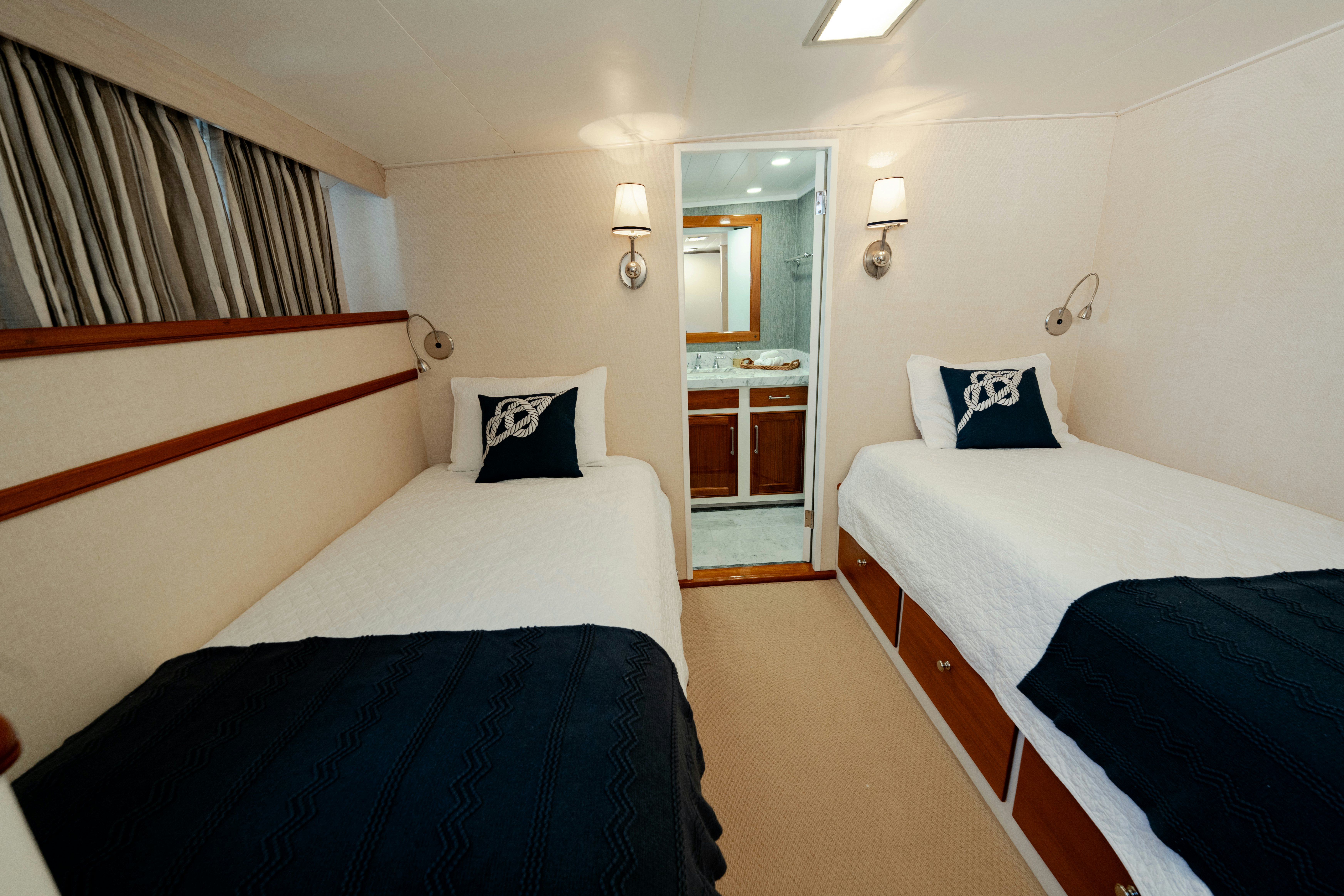 a room with beds and a door aboard NORDIC STAR Yacht for Sale