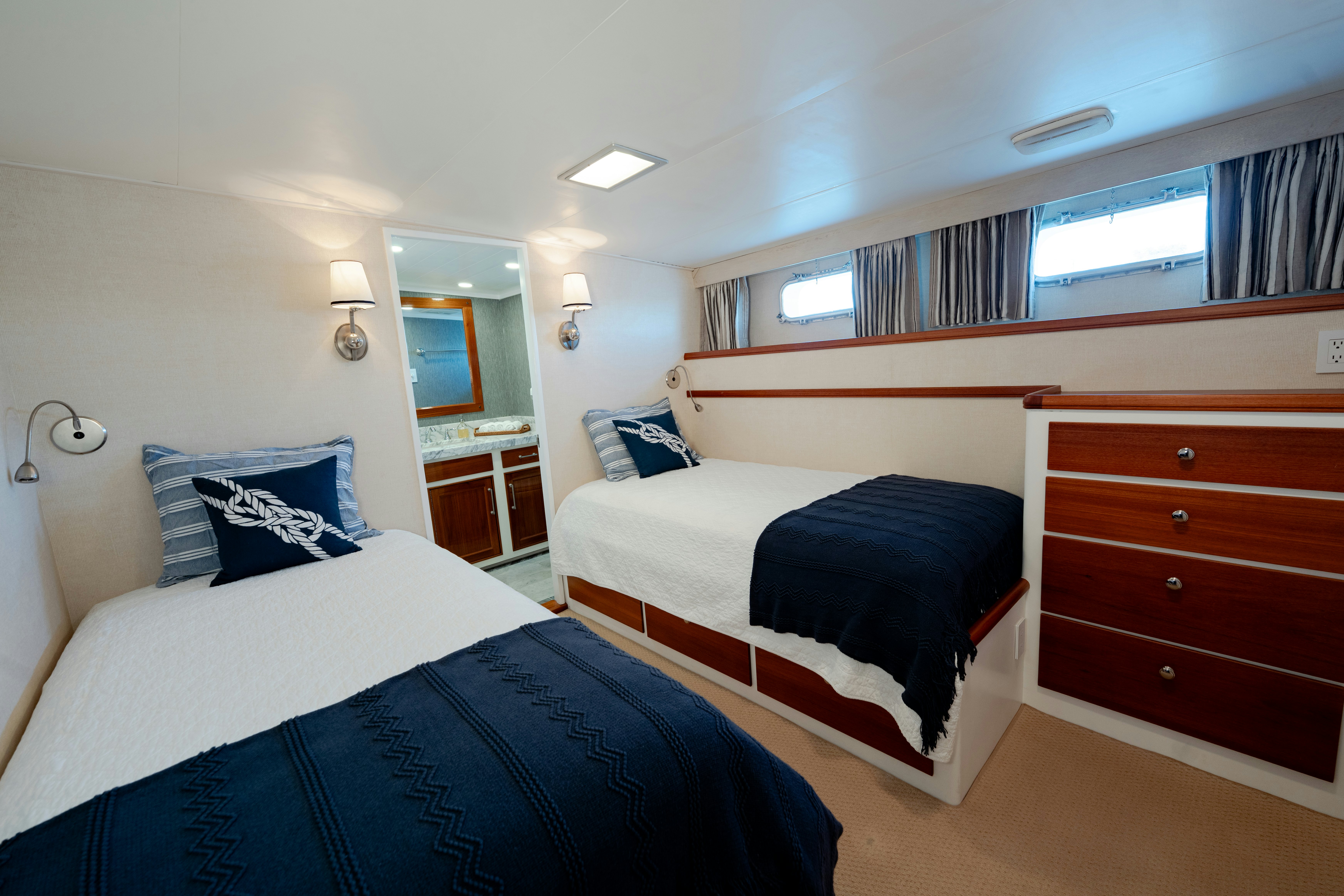 a bedroom with a couple of beds aboard NORDIC STAR Yacht for Sale