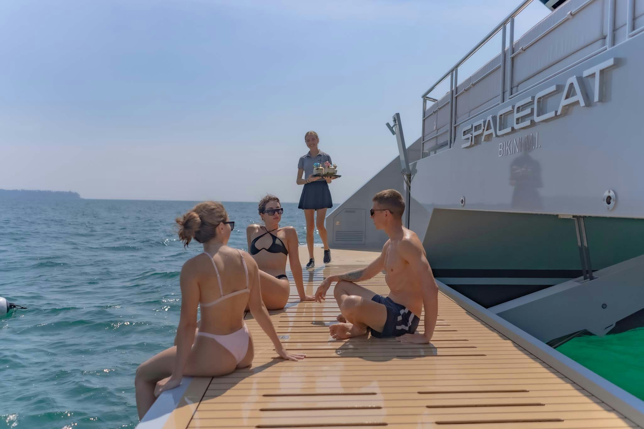 a group of people on a dock aboard SPACECAT Yacht for Charter