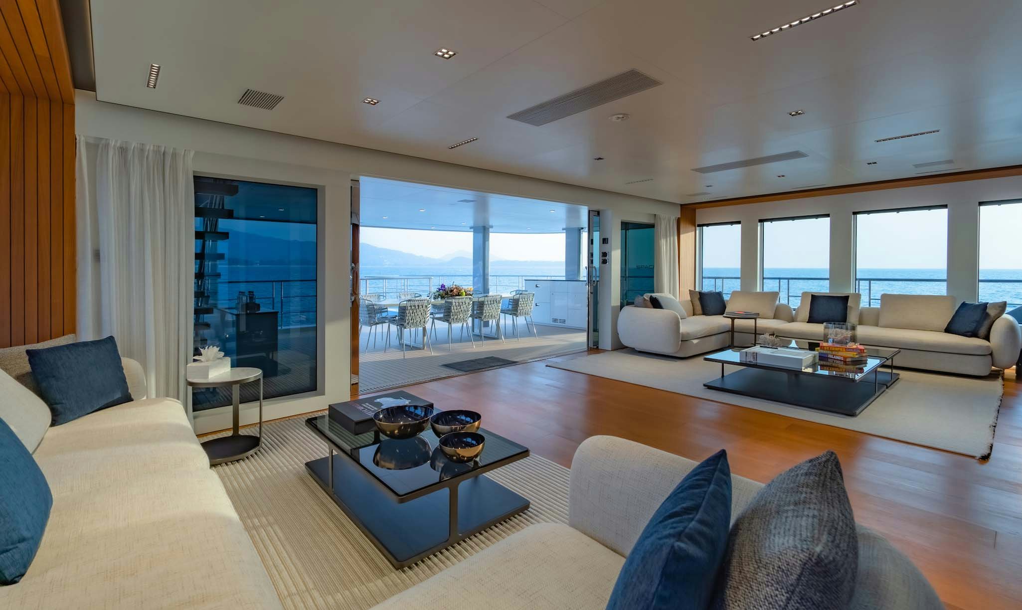 a living room with a large window aboard SPACECAT Yacht for Charter