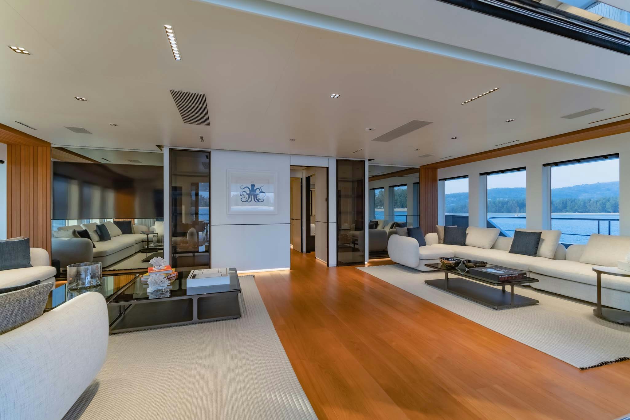 a large living room with a large window aboard SPACECAT Yacht for Charter