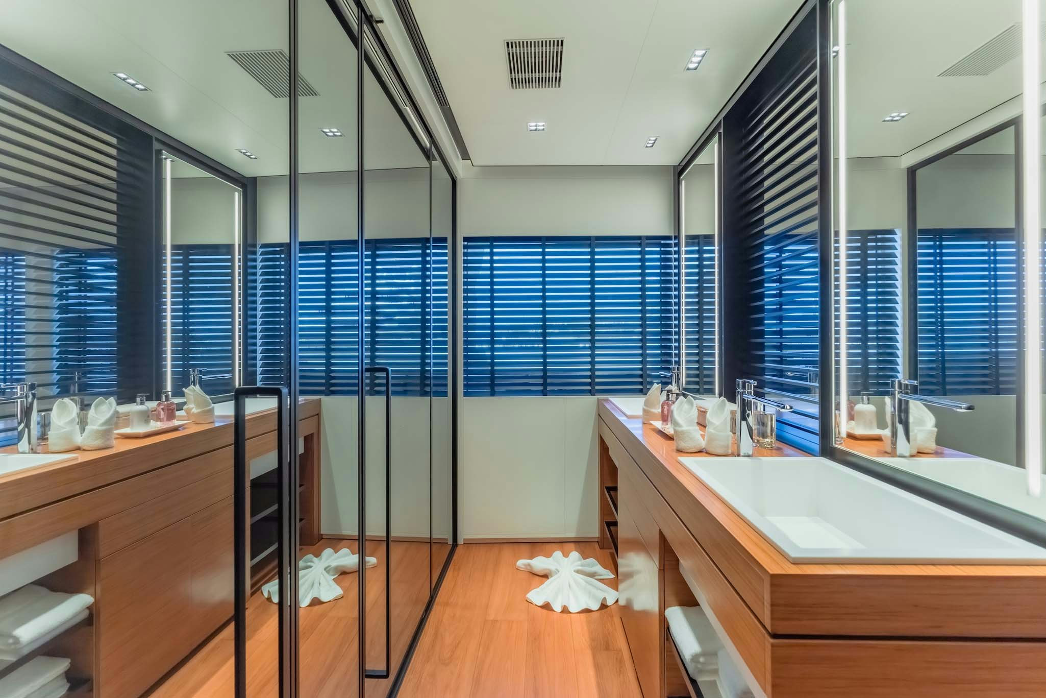 a large bathroom with glass walls aboard SPACECAT Yacht for Charter