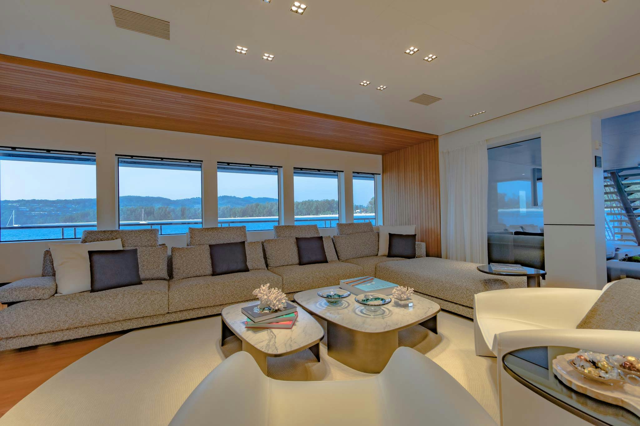 a living room with a large window aboard SPACECAT Yacht for Charter