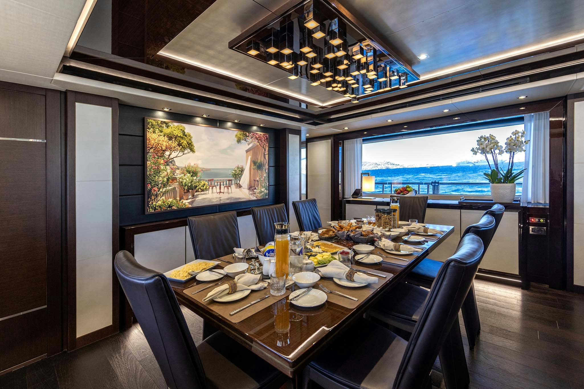 a dining room with a table set for a meal aboard NOROADER Yacht for Charter