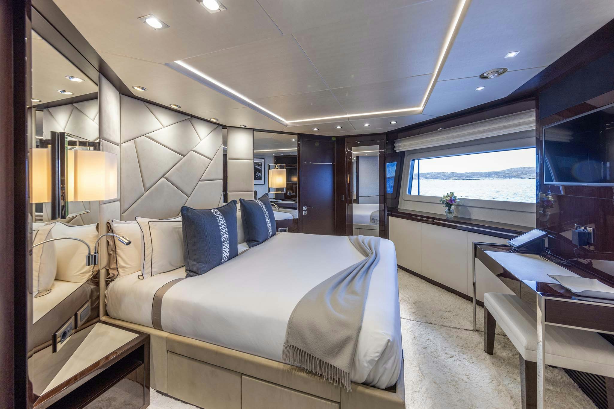 a room with a bed and a desk aboard NOROADER Yacht for Charter