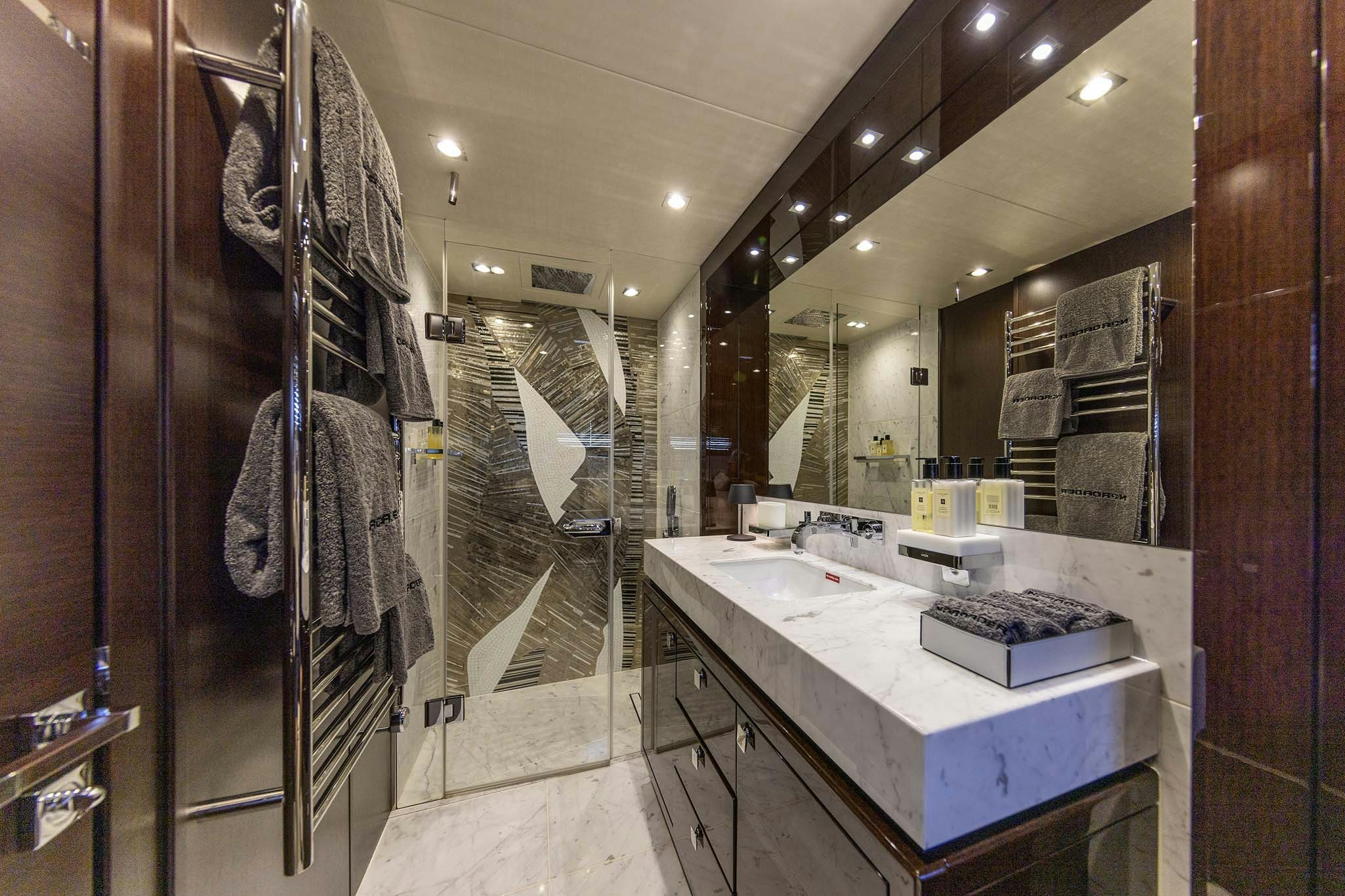 a bathroom with a countertop sink and a mirror aboard NOROADER Yacht for Charter