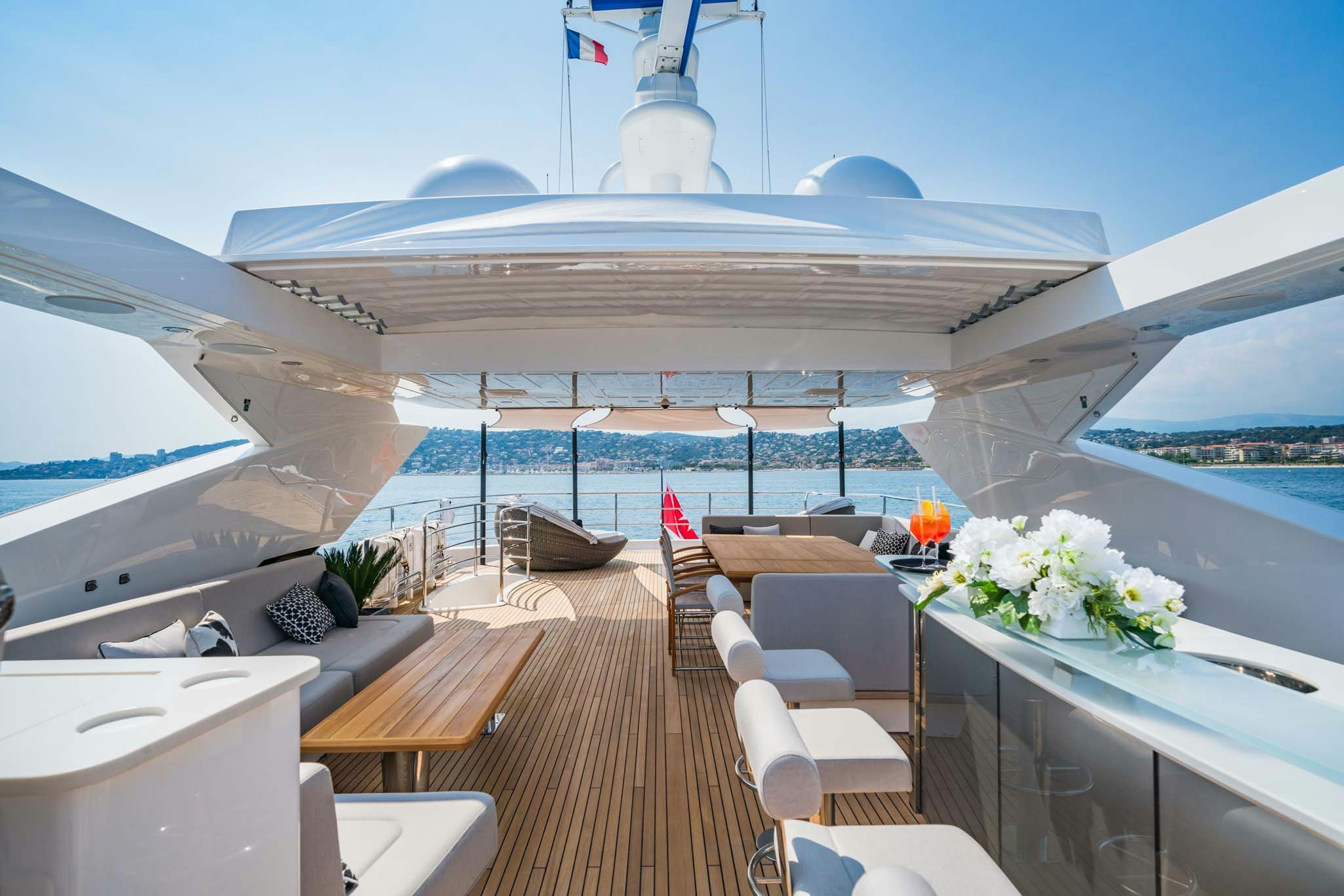 a large white building with a large deck and a large pool aboard NOROADER Yacht for Charter