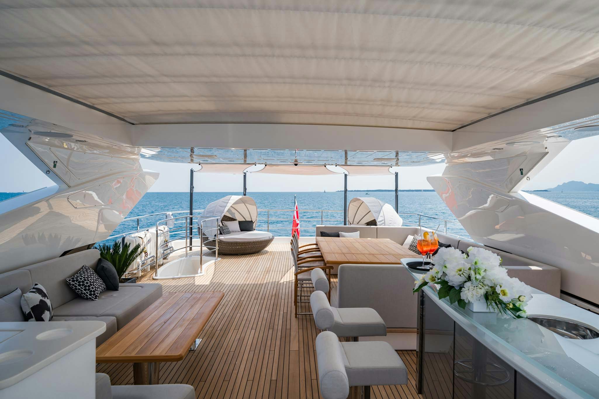 a room with a table chairs and a large window aboard NOROADER Yacht for Charter