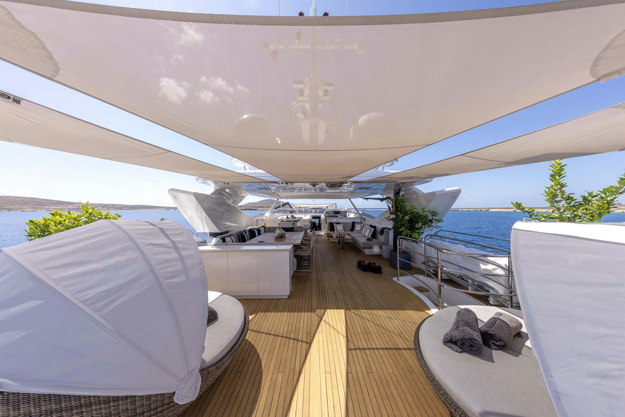 a room with a deck and a view of the water aboard NOROADER Yacht for Charter