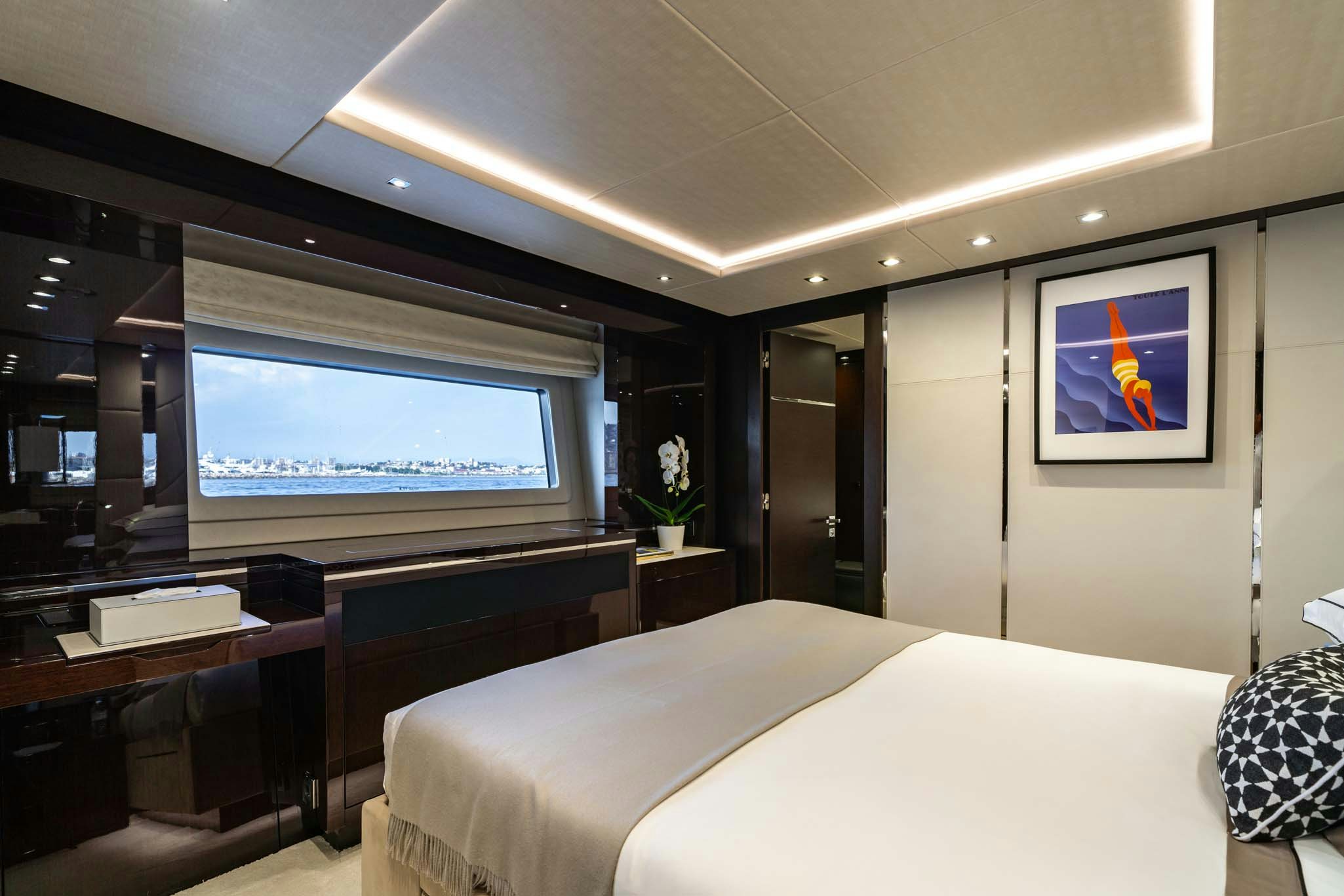 a hotel room with a bed and desk aboard NOROADER Yacht for Charter