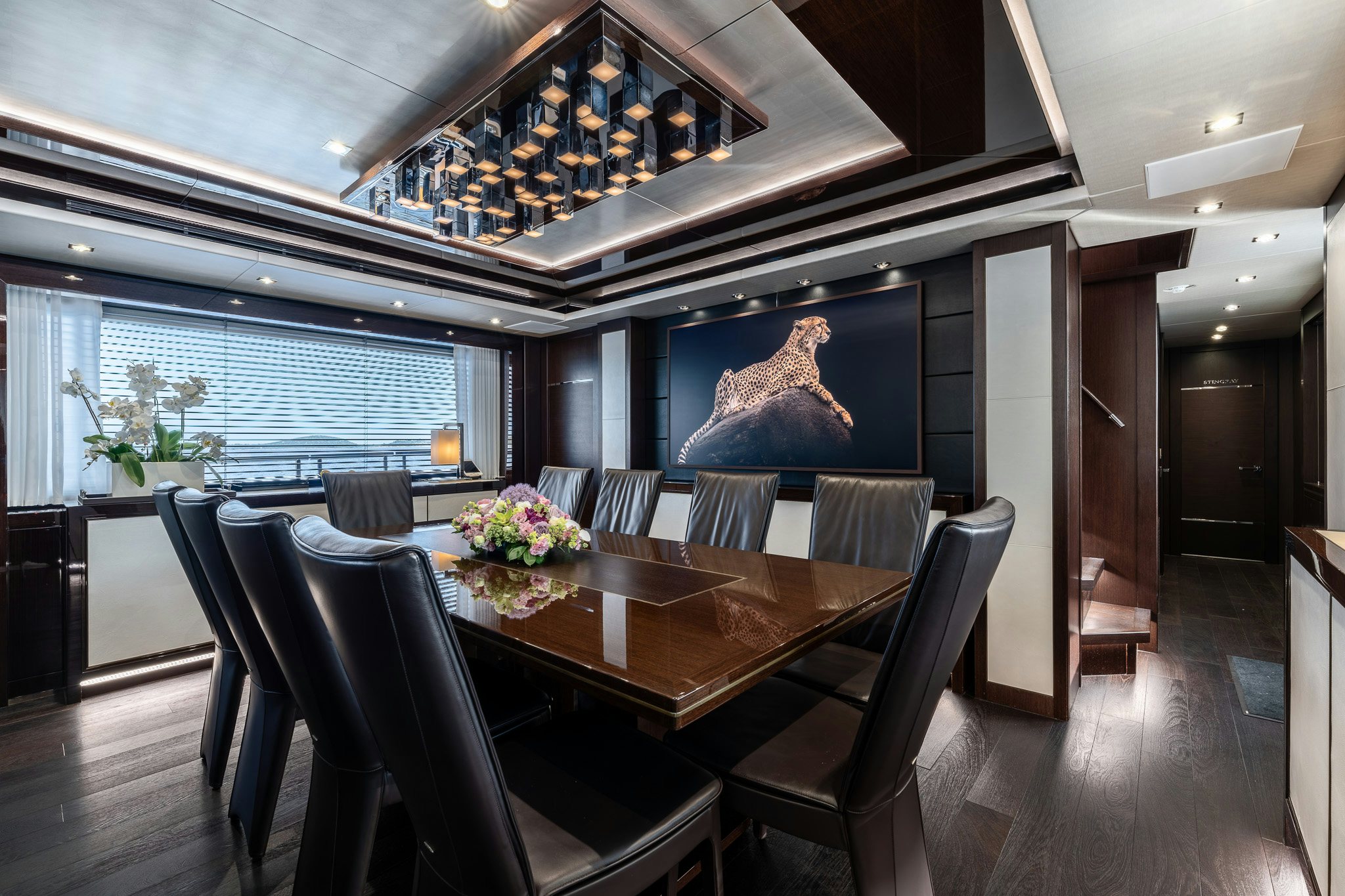 a dining room with a large chandelier above it aboard NOROADER Yacht for Sale