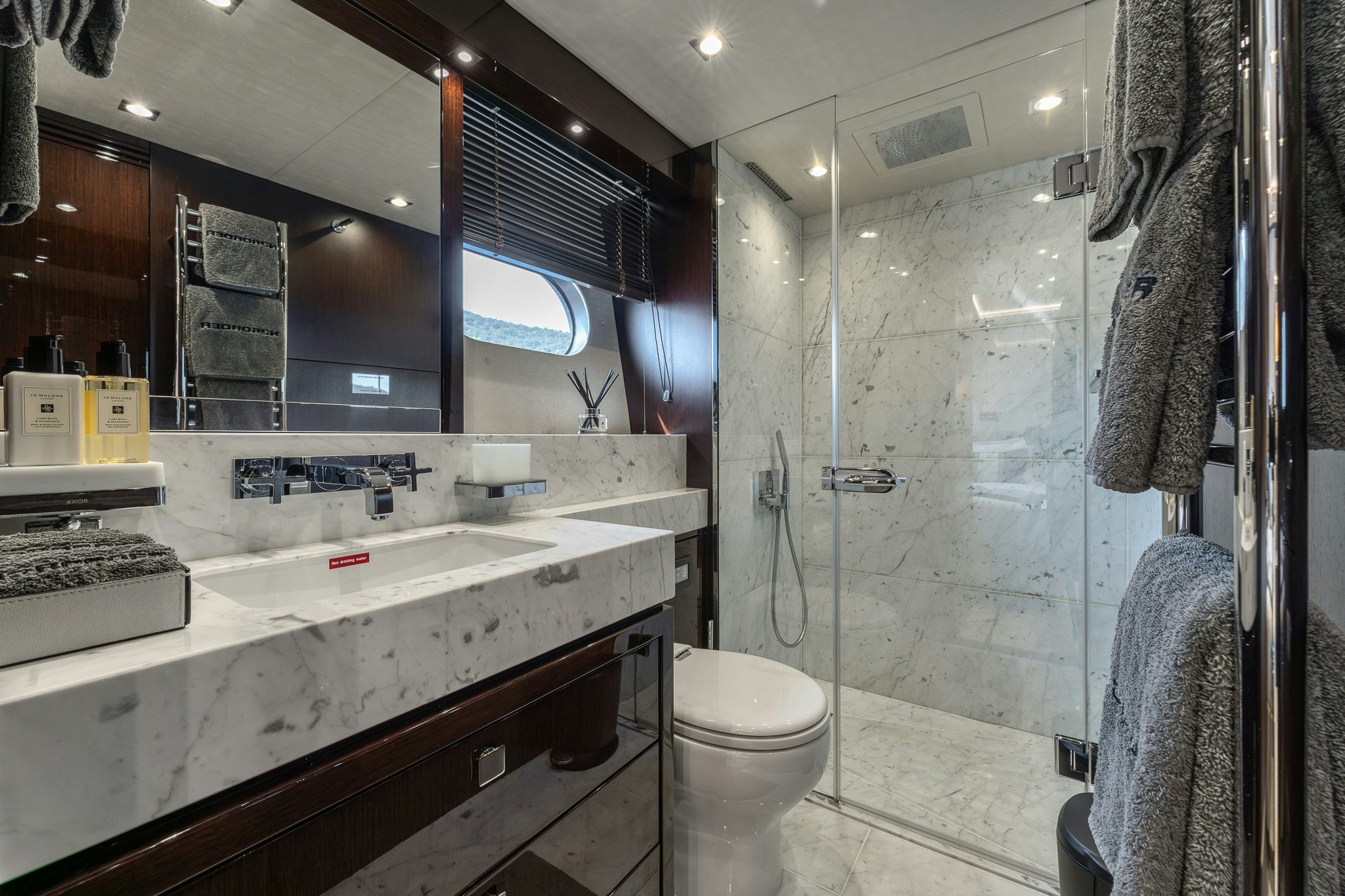 a bathroom with a glass shower aboard NOROADER Yacht for Sale