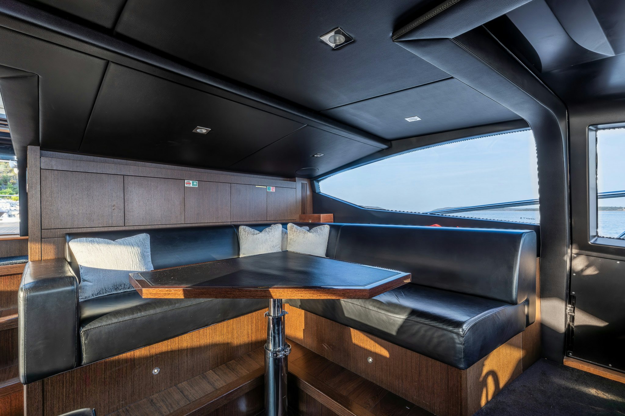 a couch and a table in a room aboard NOROADER Yacht for Sale