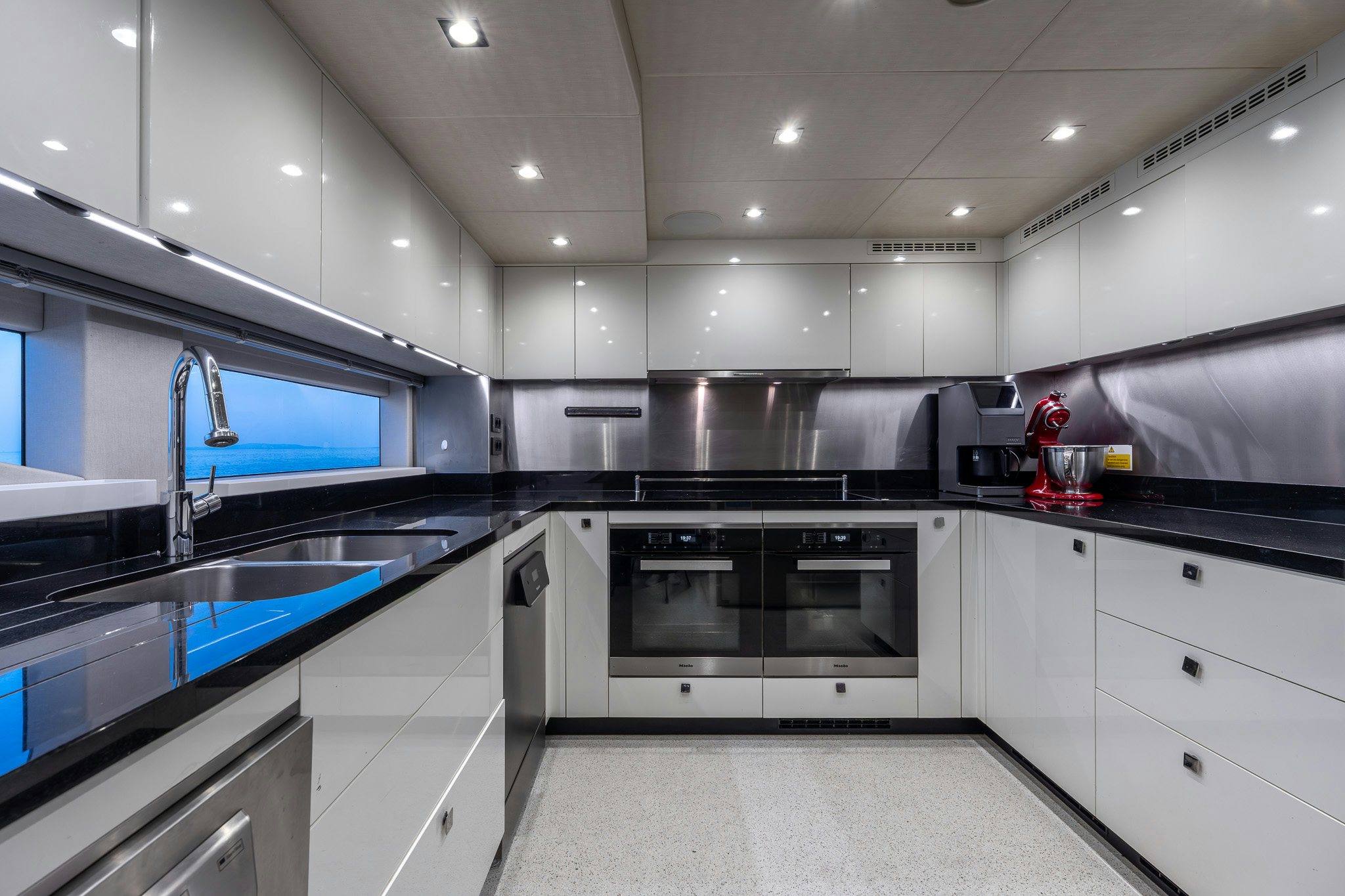a kitchen with white cabinets aboard NOROADER Yacht for Sale