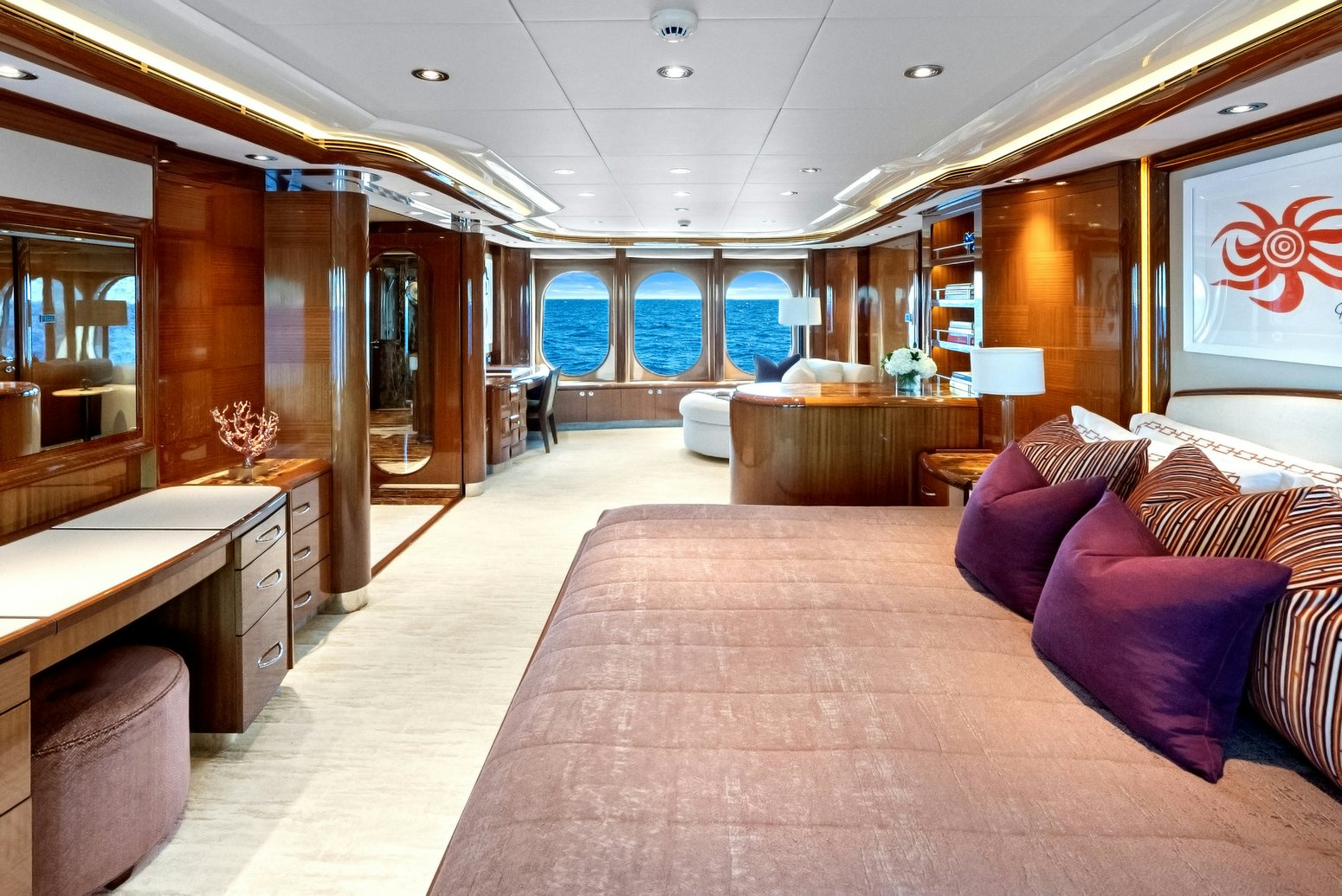 a large bedroom with a bed and a desk aboard AMICA MEA Yacht for Charter