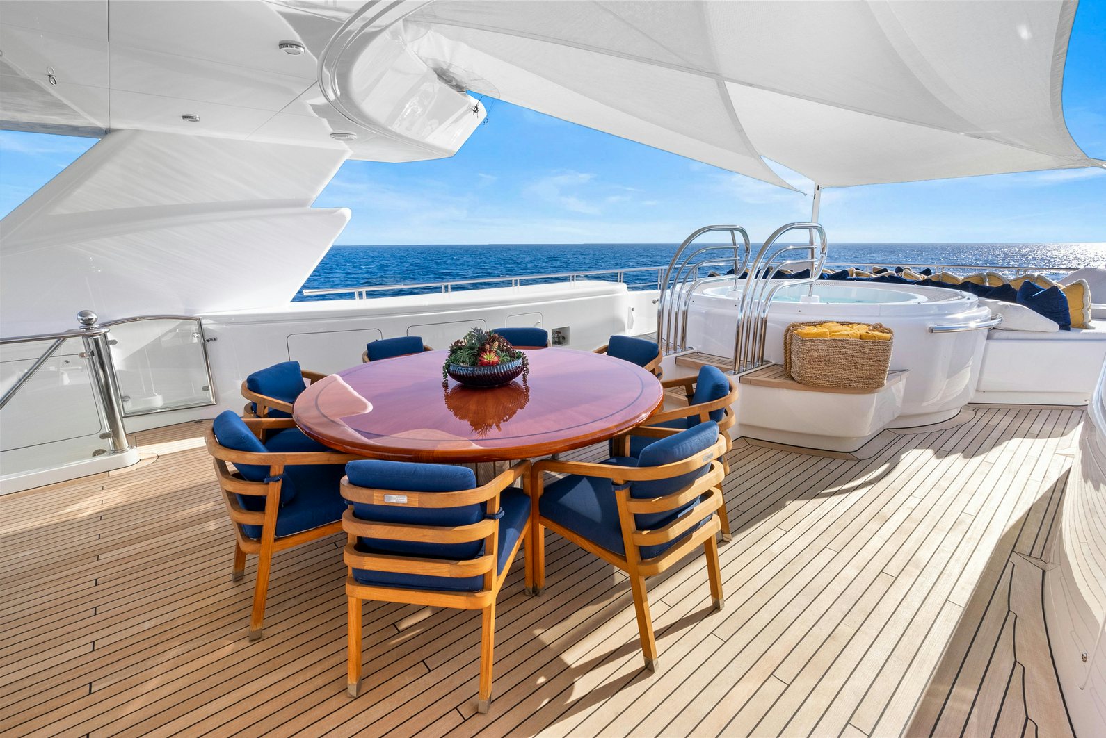 a table and chairs on a deck aboard AMICA MEA Yacht for Charter