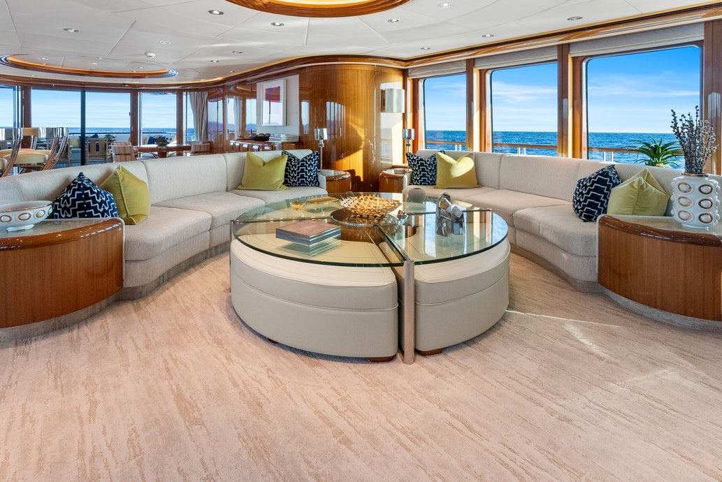 a living room with a large sofa aboard AMICA MEA Yacht for Charter