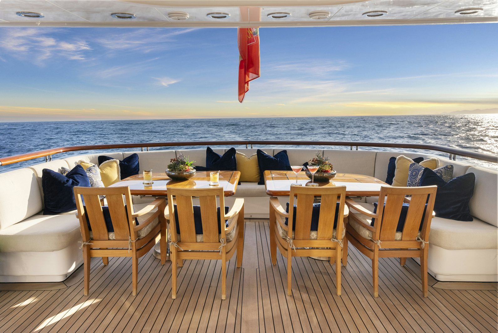 a deck with chairs and tables aboard AMICA MEA Yacht for Charter