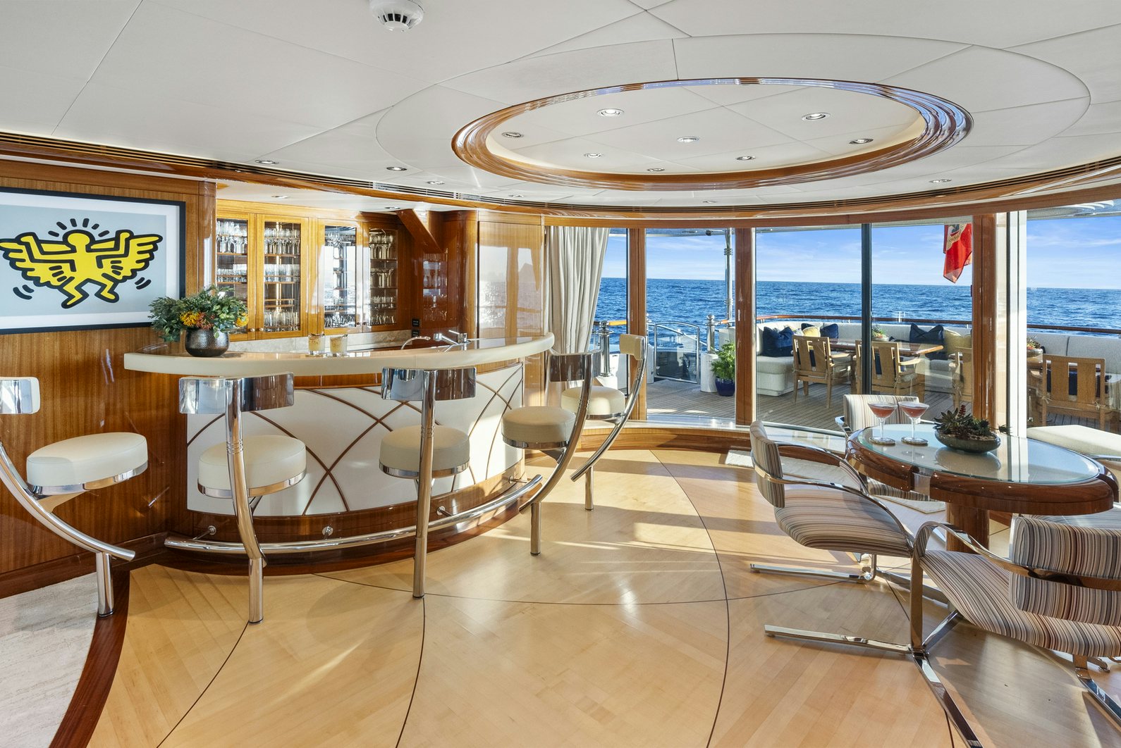 a room with a table chairs and a large window aboard AMICA MEA Yacht for Charter