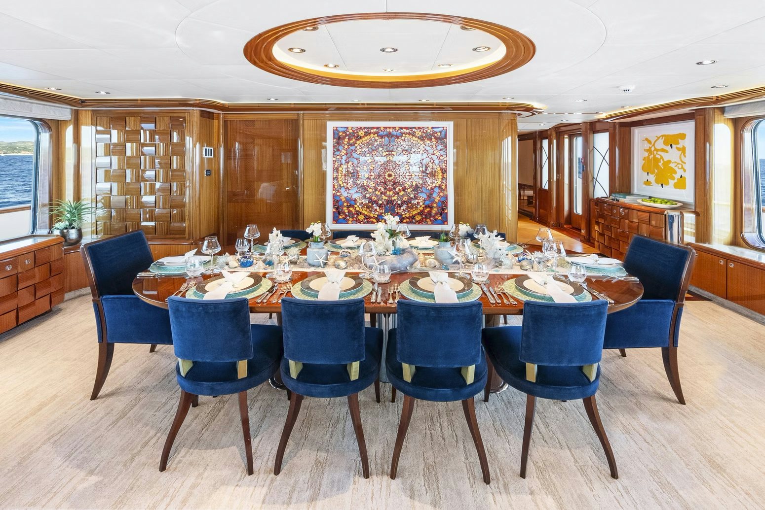 a large dining room with blue chairs aboard AMICA MEA Yacht for Charter